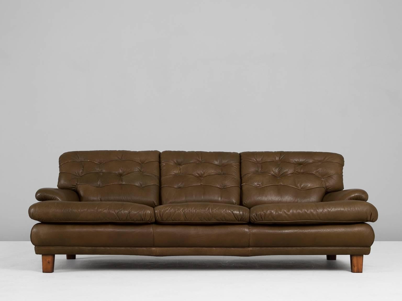 Sofa, in leather and wood, by Arne Norell, Sweden, 1960s.

Excellent three-seat sofa with green leather by Swedish designer Arne Norell. Upholstered in beautiful patinated brown-green leather. Highly comfortable sofa, a trademark of Norell. 

As