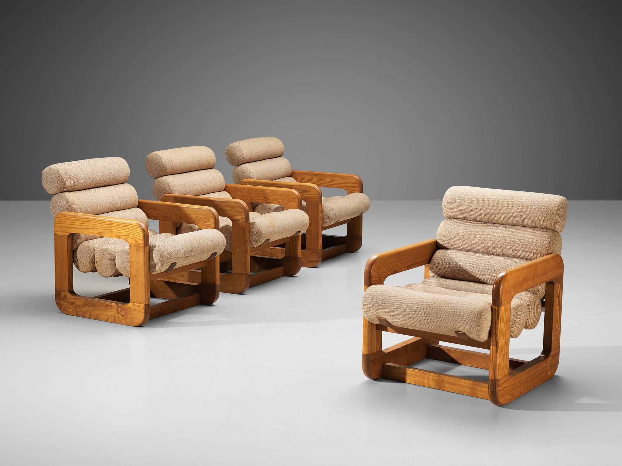 Lounge chairs, ash, fabric, Europe, 1970s.

Set of four unconventional lounge chairs that feature an outstanding design. The seating contains multiple tube-shaped cushions attached together to create a seat and backrest. The repetition of the