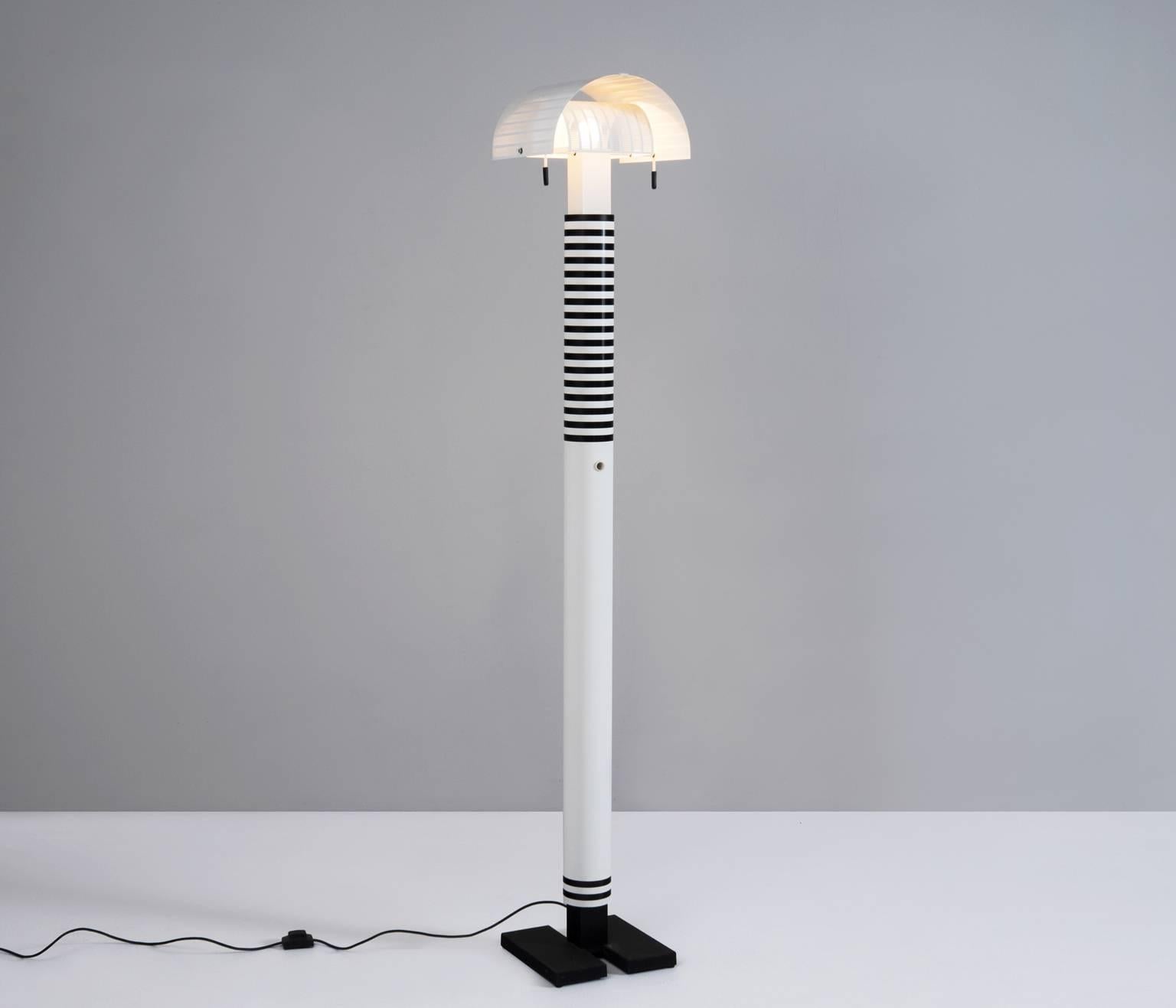 Italian floor lamp designed by the Italian architect, Mario Botta for Artemide, 1980s.

The black base is made of cast iron, the powder coated shaft is back and white striped. Two curved perforated diffusers can be pivoted to create endless