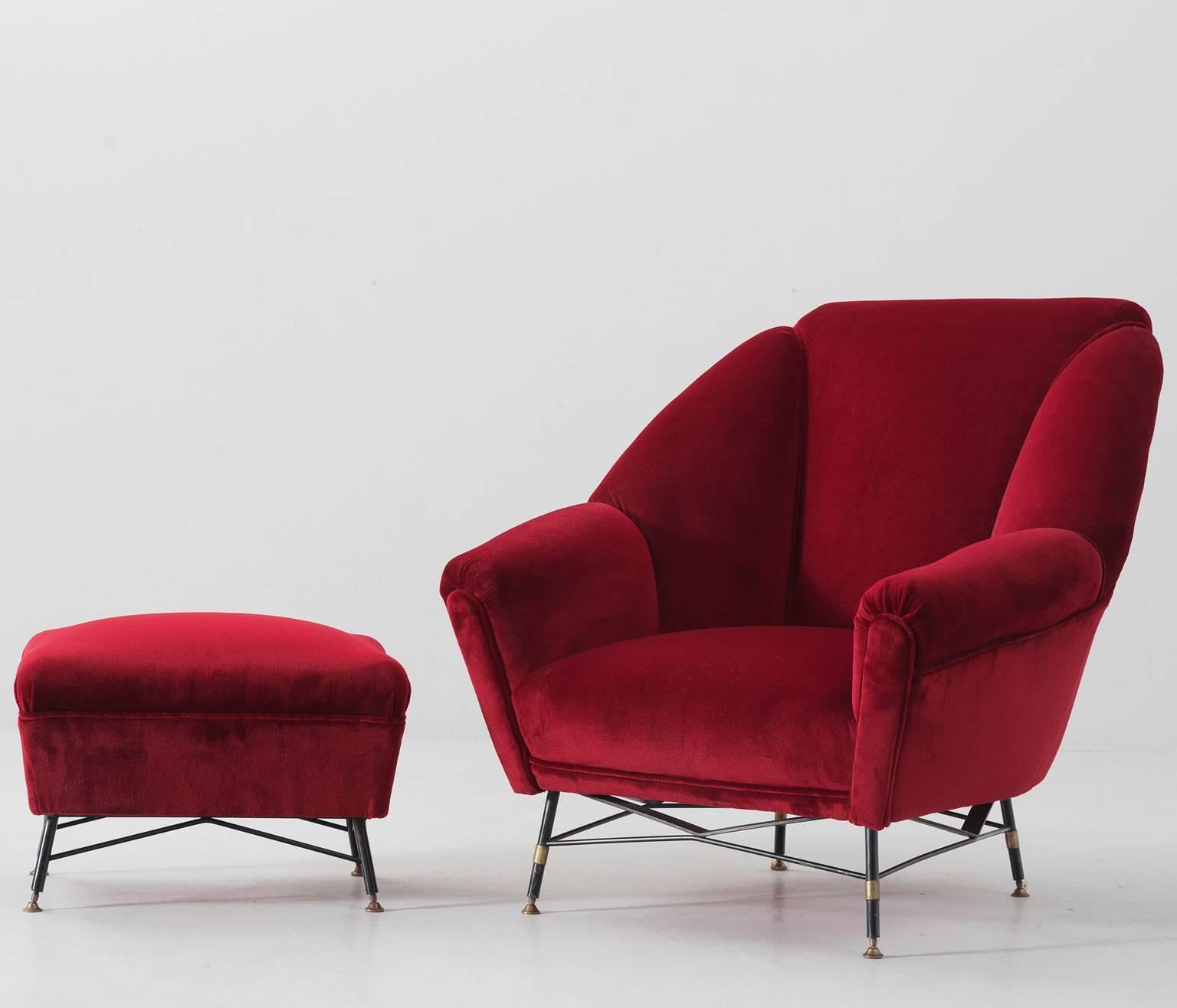 Lounge chair and footstool, in fabric and metal, Italy 1950s.   

Lounge chair, with accompanying hocker. Designed and made in Italy in the style of Augusto Bozzi. Elegant organic shaped easy chair in red velvet upholstery, made with nicely shaped