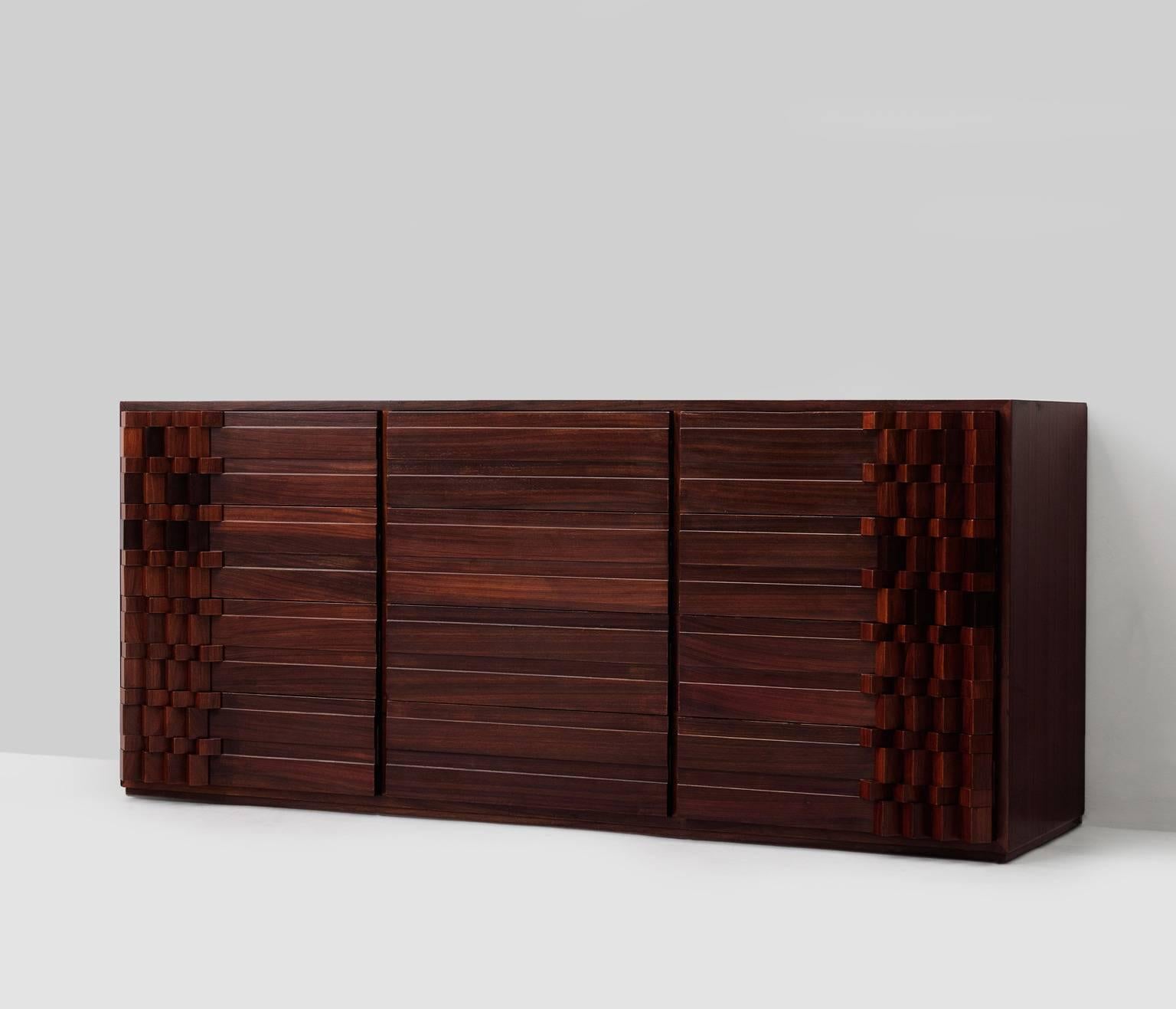 Cabinet, in rosewood, by Luciano Frigerio, Italy, 1970s.

This rosewood dresser is very smart designed and hold plenty of storage facility. The expressive fronts made of solid rosewood slats gives this credenza its unique appearance. The rosewood