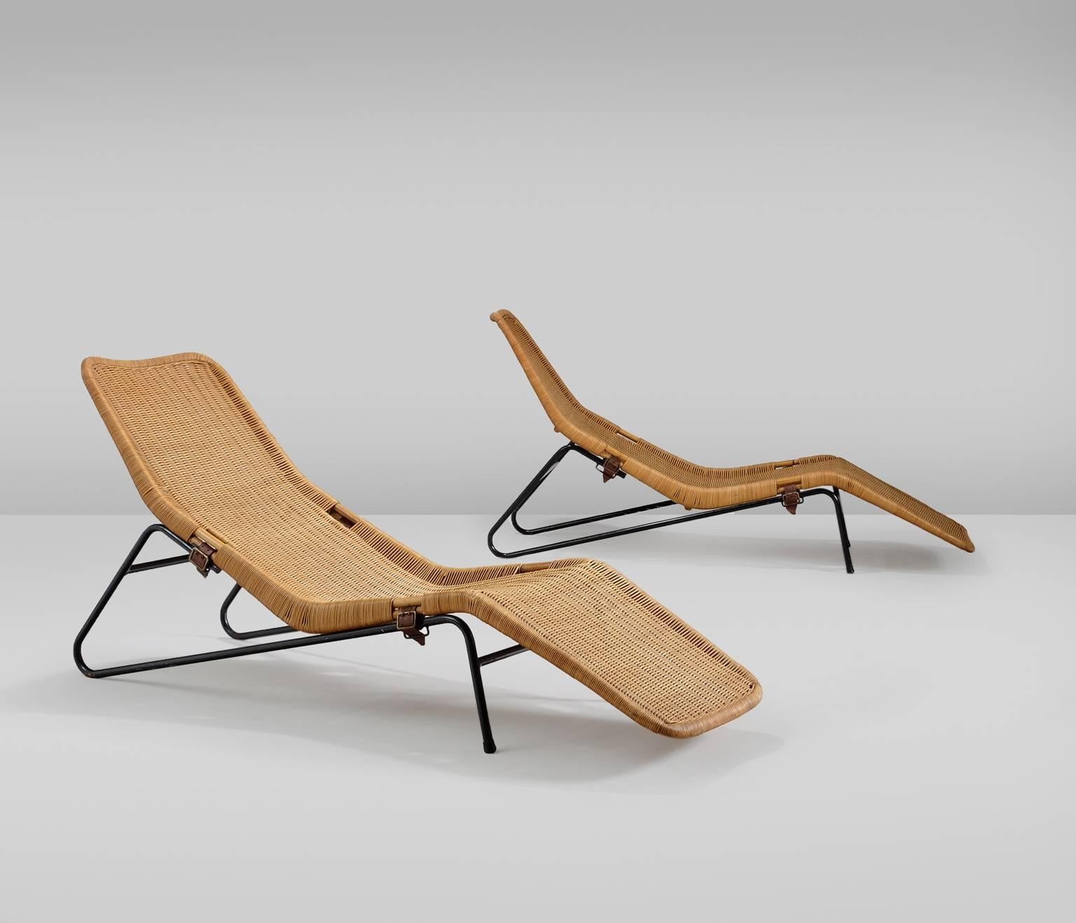 This very rare set of two lounge chairs are examples of the very high quality.

The combination of the painted steel frames with a webbing of cane (wicker) pattern makes a beautiful modernist chaise longue finished with leather belts.
The frame