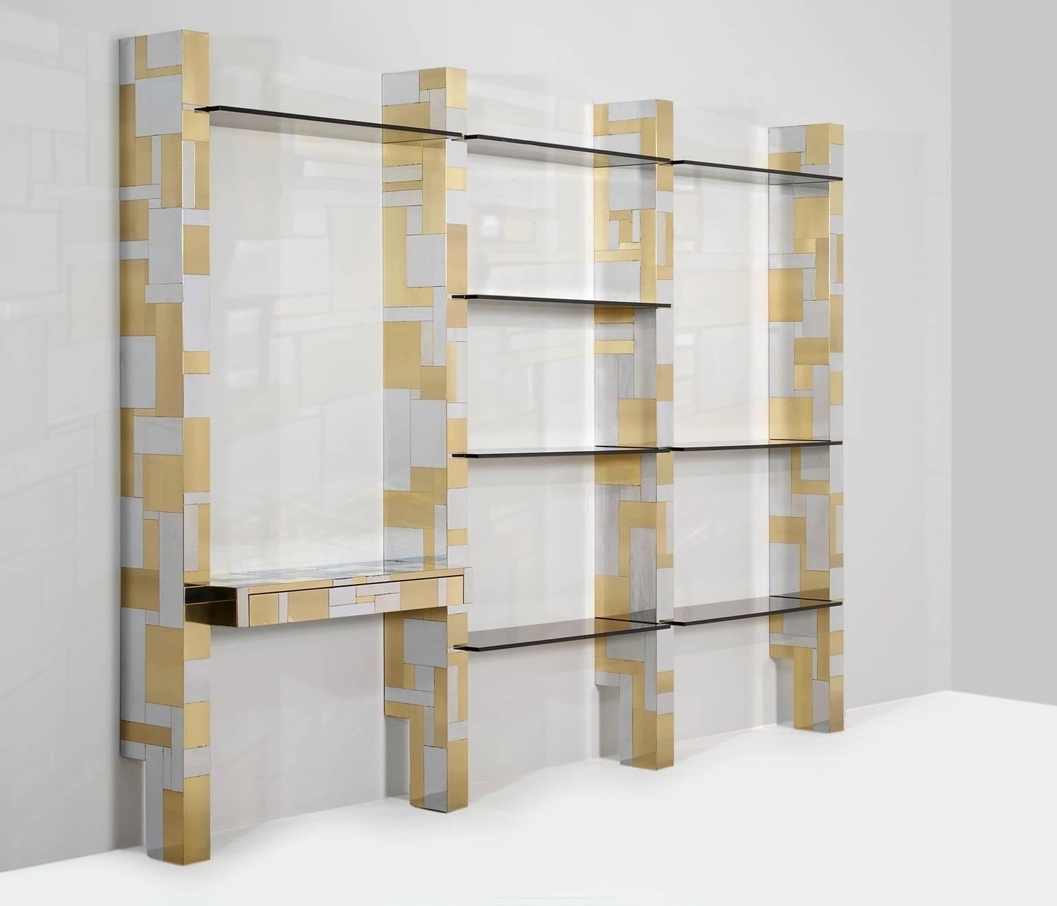 Wall console 'Cityscape', in brass, glass, wood and metal by Paul Evans, United States 1970s. 

Striking wall unit made of brass and chrome from the 'cityscape' collection.
Equipped with multiple colored glass shelves and a desk with