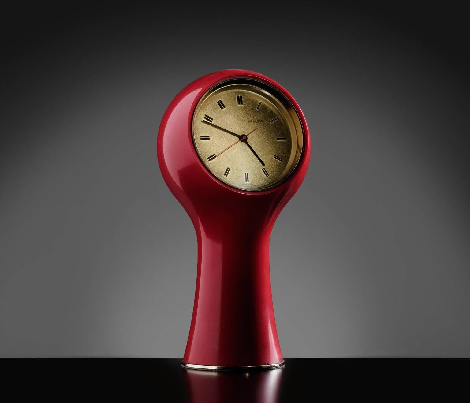Clock, in metal and plastic, by Angelo Mangiarotti, Italy 1960s. 

Swiss made bright red table clock designed by Angelo Mangiarotti in the 1960s. This 'Space Age' era clock is detailed with brass details.

Angelo Mangiarotti, an Italian