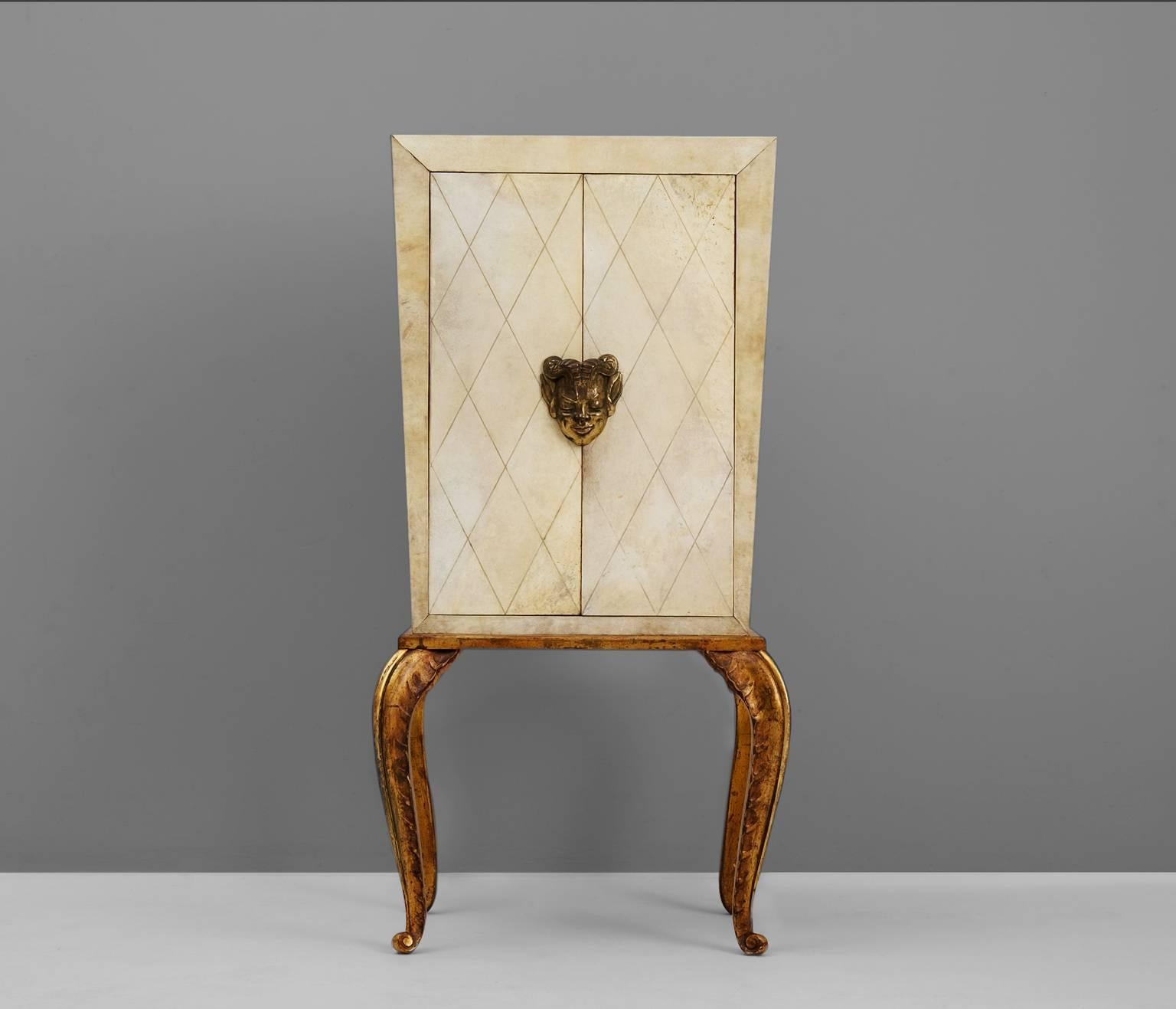 Cabinet, in parchment and wood, by Maison Jansen, France, 1940s. 

A rare and beautiful small cabinet designed by Parisian decorator Maison Jansen. This cabinet is made in sycamore wood, paneled with parchment and beautifully hand-sculpted gilded