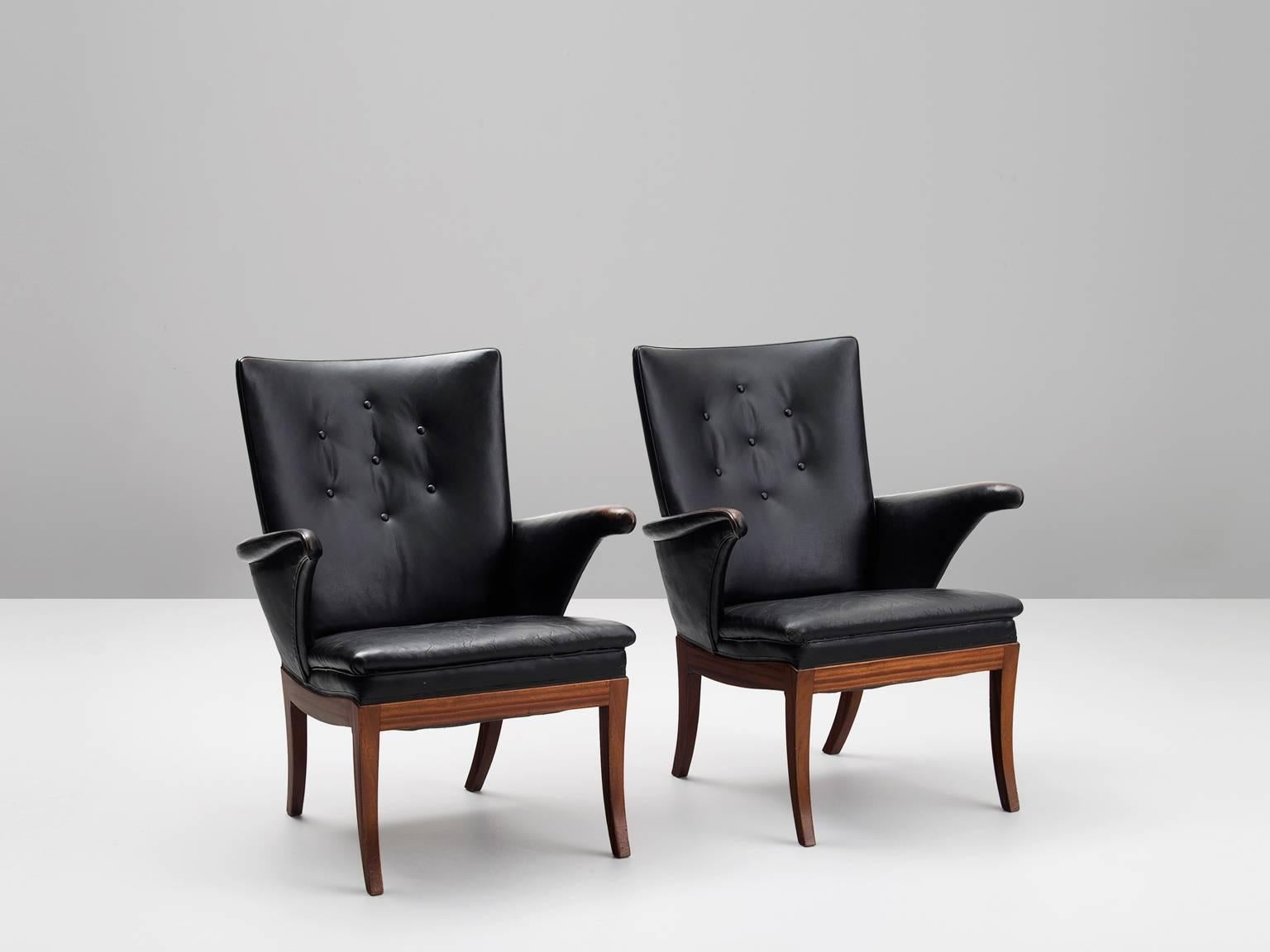 Frits Henningsen, pair of black leather armchairs, Denmark 1932.

This pair of comfortable lounge chairs was designed and produced by master cabinet maker Frits Henningsen (1989-1965) in circa 1932. The remarkably well-crafted pair shows the