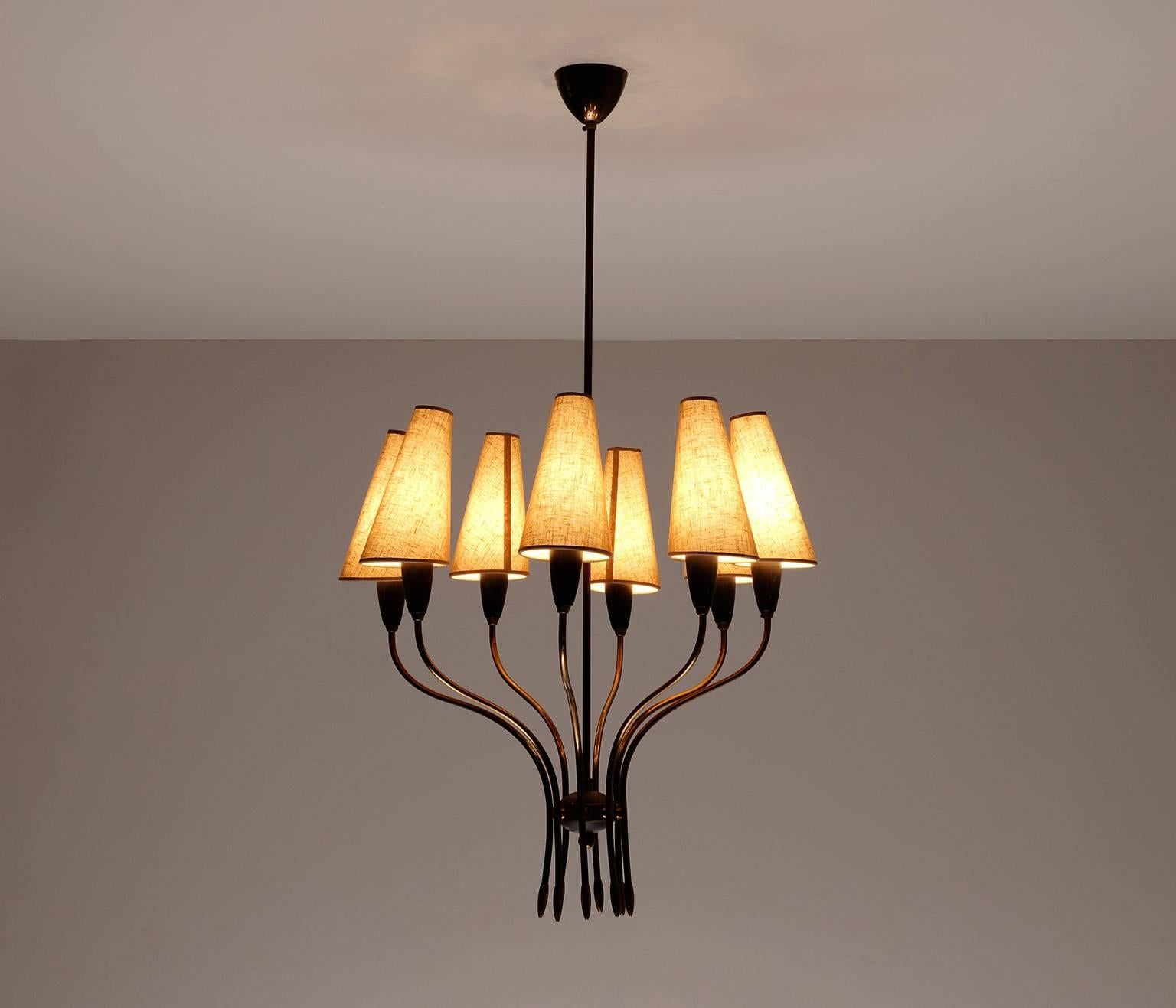 Stunning chandelier in brass with decorative shades and details, France, 1950s.

The eight shades provide a soft light which also gives this chandelier an elegant expression. French made with care as seen in some details as organic shapes. The stem