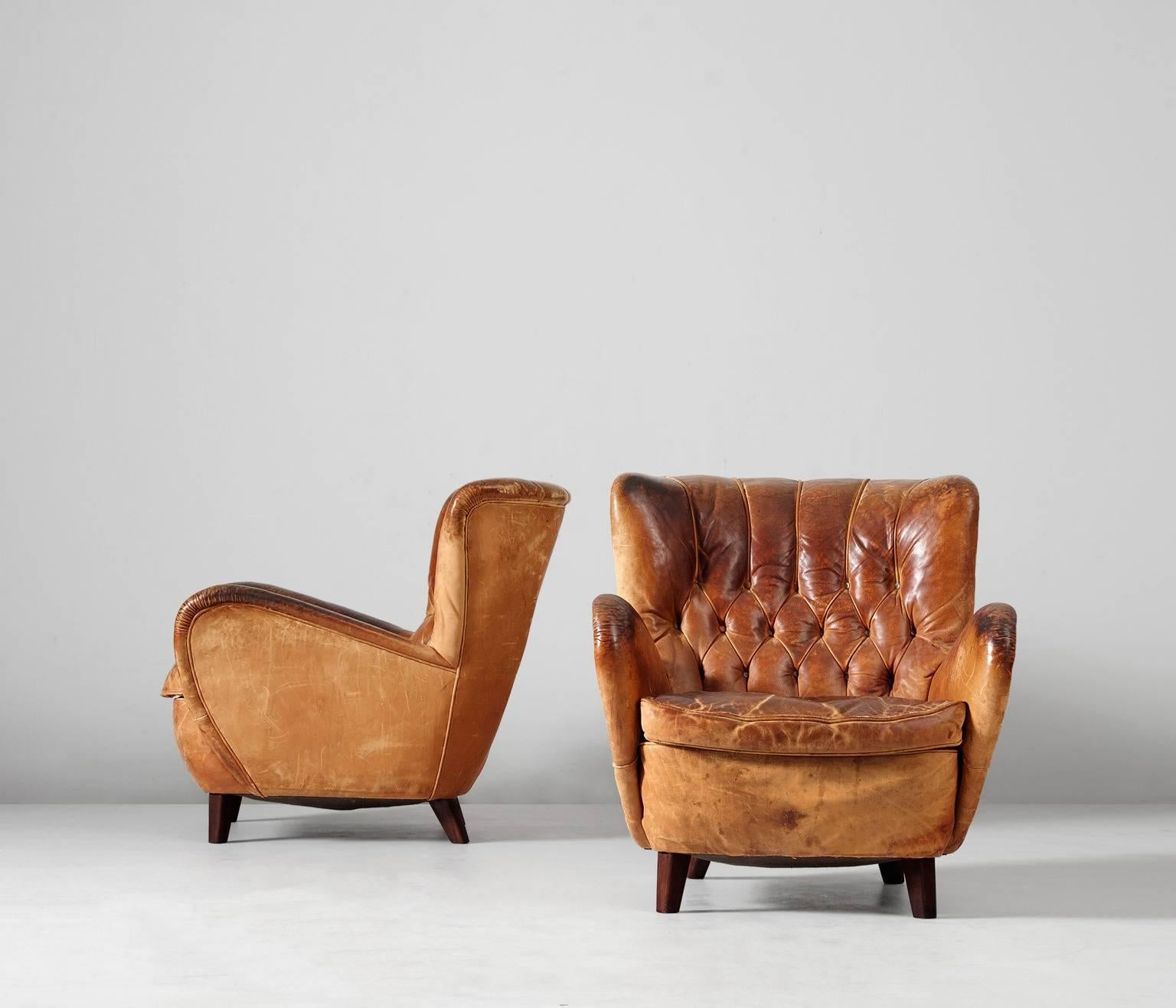 Really nice patinated brown cognac leather set of lounge chairs, Europe, 1940s.
This set of easy chairs is completely original. A very nice addition to every modern interior. 

The original leather is very nicely patinated with strong expression