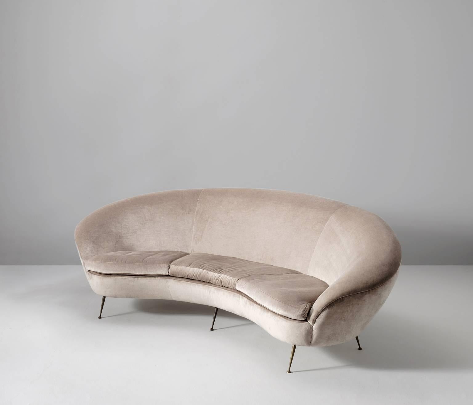 Large curved sofa in velvet, Italy 1950s. 
  
This large three-seater sofa has a rich appearance due its shape and material. The armrests run over smoothly into the back and provide elegant round curves, which gives it a feminine and intimate