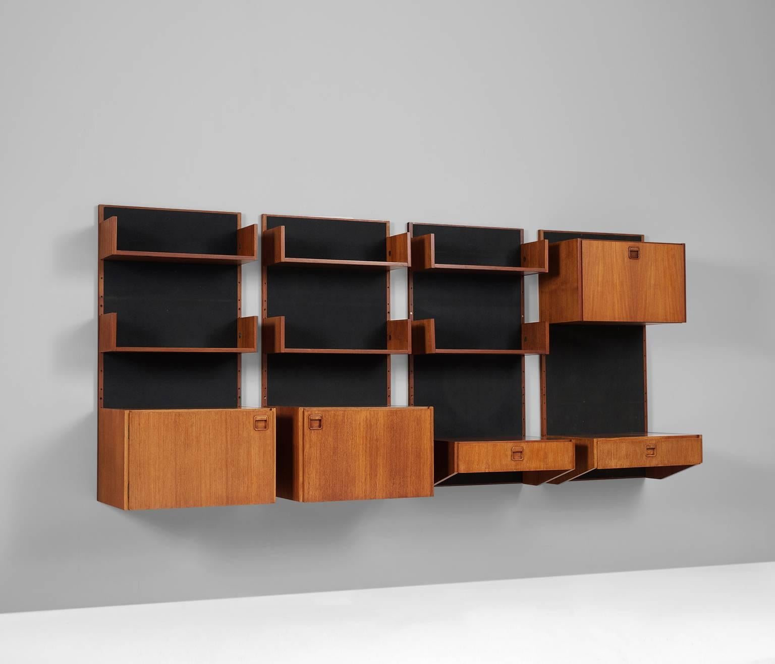 Wall Console in teak, Scandinavia 1950s.

Sophisticated wall console in teak. The wall module consists of four vertical elements with a black background. Every element is equiped with several shelves, cabinets or drawers.

The combination of