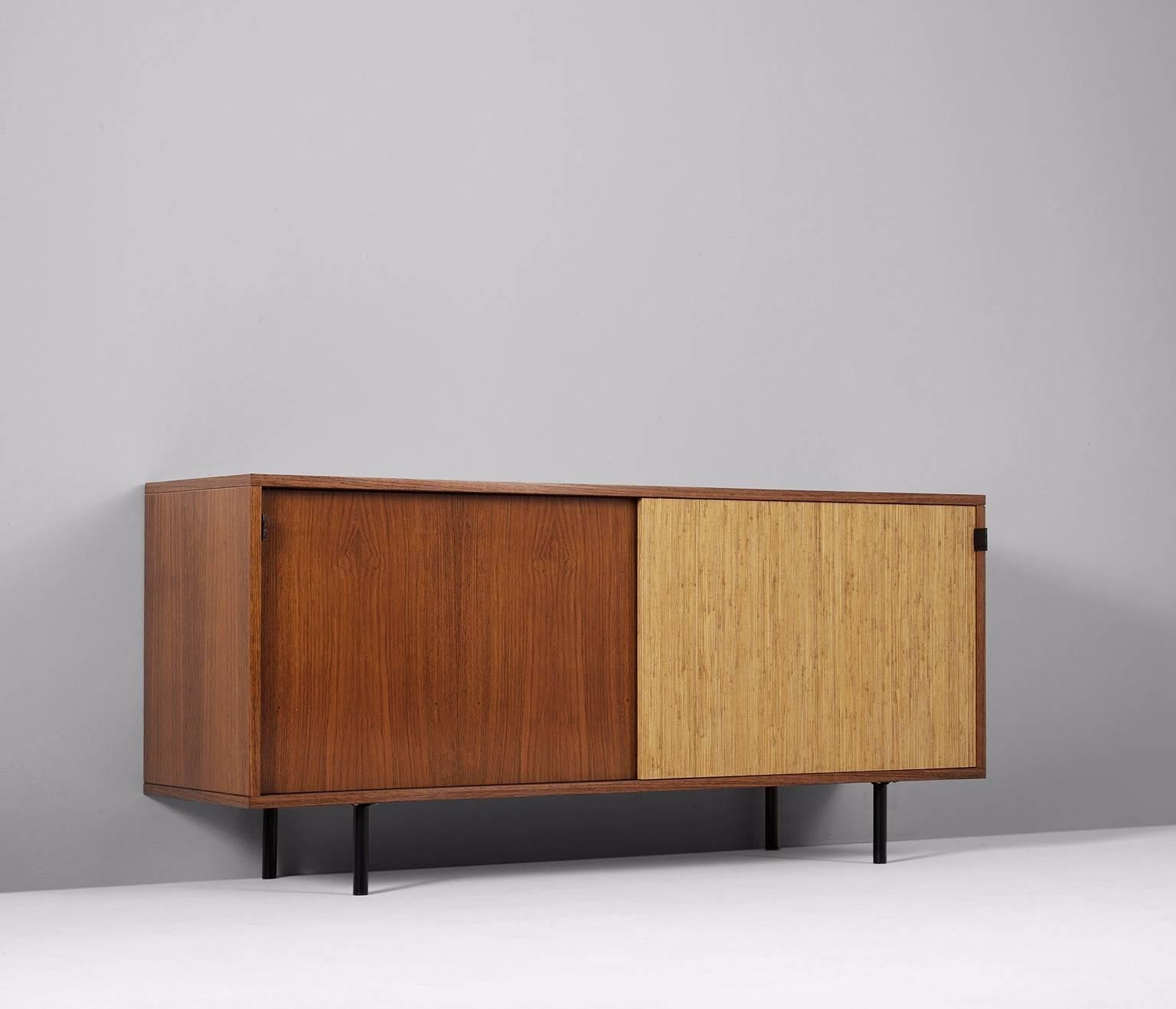Sideboard model 116 in rosewood, raffia, steel and leather, by Florence Knoll, United States 1948. 

An early office-residential crossover piece. The credenza has two sliding doors, one covered with seagrass. Inside there are several shelves.