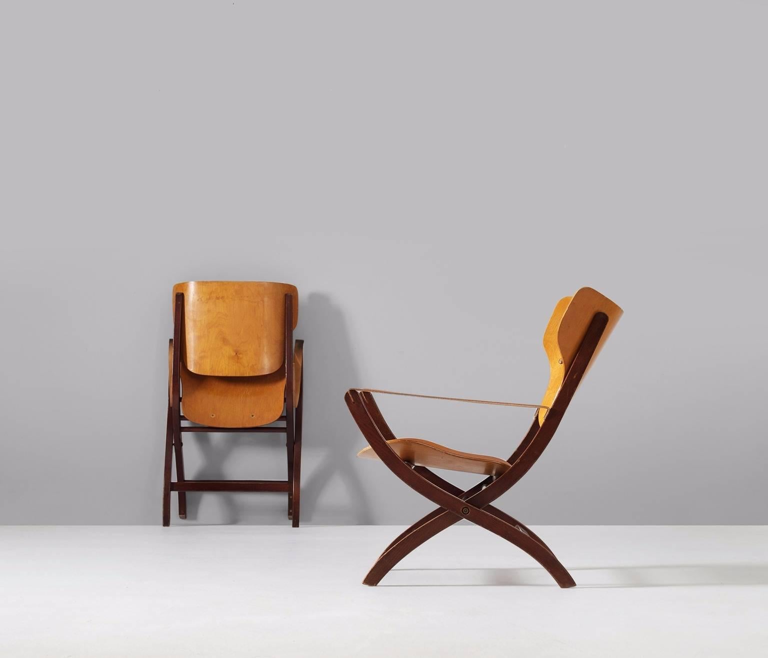 A pair of Egyptian chairs, in beech and birch, by Poul Hundevad, Denmark 1950s. 

These folding chairs have X- shaped legs, inspired on ancient Egyptian thrones and chairs. The frame is from solid beech, stained in a dark brown/ ruby red color.