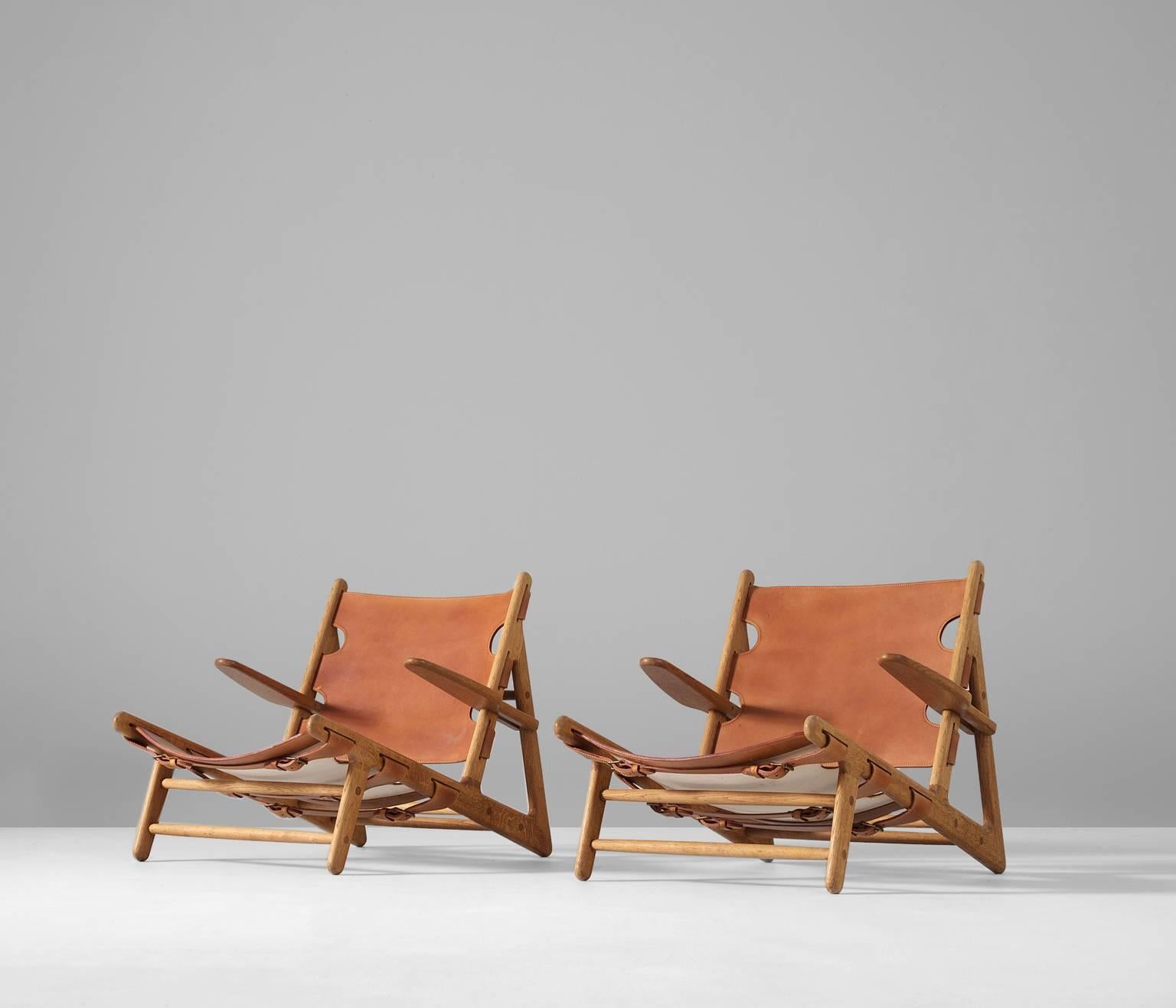 Hunting chairs, in oak and cognac saddle leather, by Børge Mogensen for Fredericia Stolefabrik, Denmark 1950.  

The hunting chair was Mogensens first work with a solid wooden frame and saddle leather seating. This iconic piece was the first in a