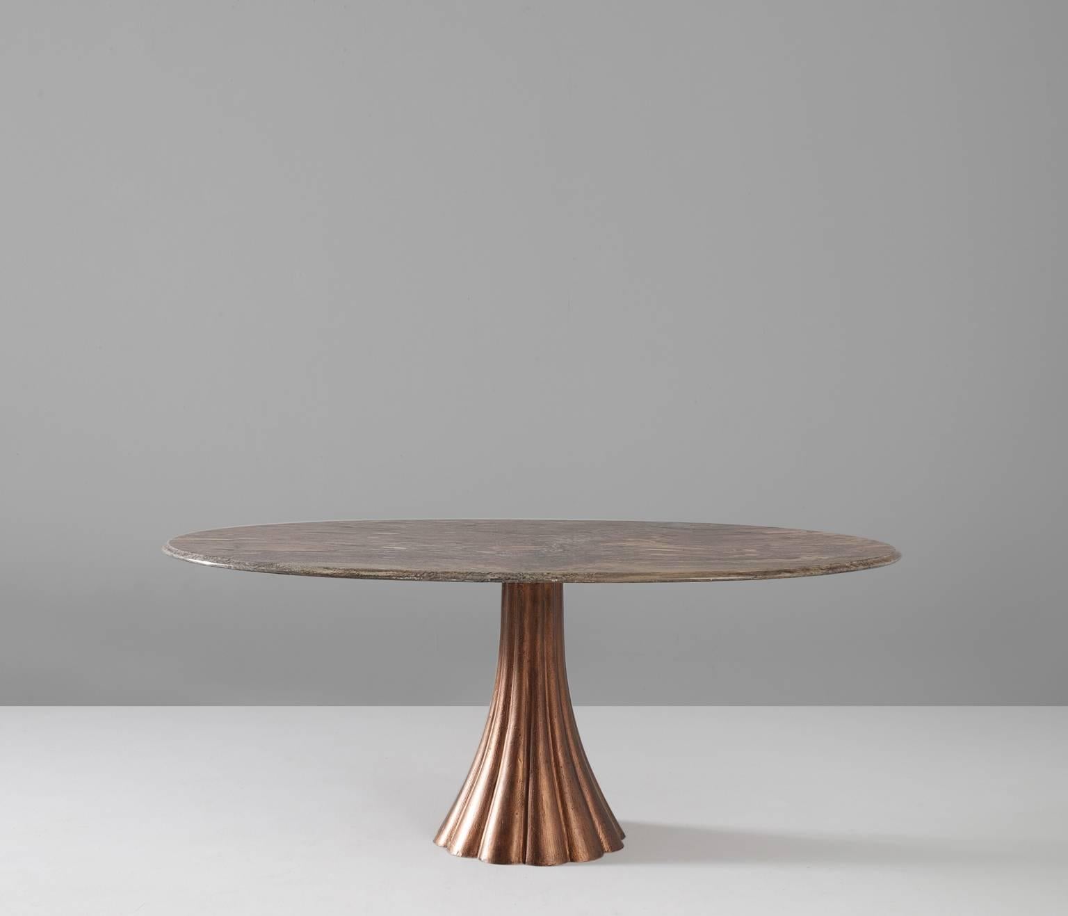 Pedestal table, in marble and iron, Italy, 1960s. 

The oval shaped marble top of this dining table shows a magnificent color palette. The white and pink lines on the grey surfaces emphasize the almost theatrical appearance of this piece.

The