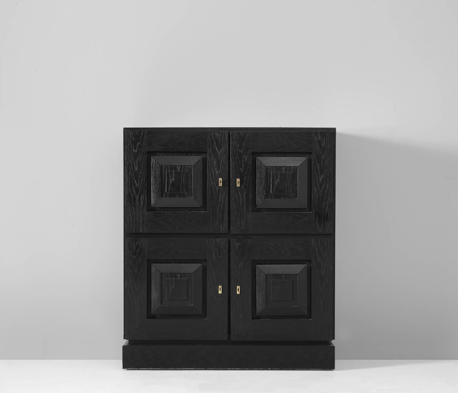 Black Brutalist highboard, European, 1970s. 

Brutalist credenza in black lacquered oak with graphical designed doorpanels. Four doorpanels, each with a three-dimensional pattern of a square, which gives the cabinet a very strong expression. 
