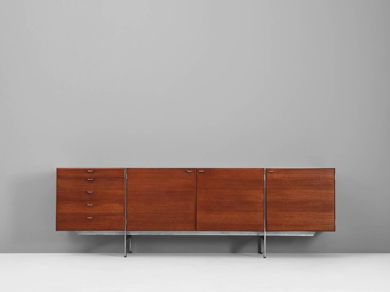 Sideboard model K6024, in teak and steel, by Ib Kofod-Larsen, Denmark 1962. 

Exceptional and highly rare credenza in teak on stainless steel base, designed by Ib Kofod Larsen. Three doors, equipped with shelves, one set of drawers. Nice visible