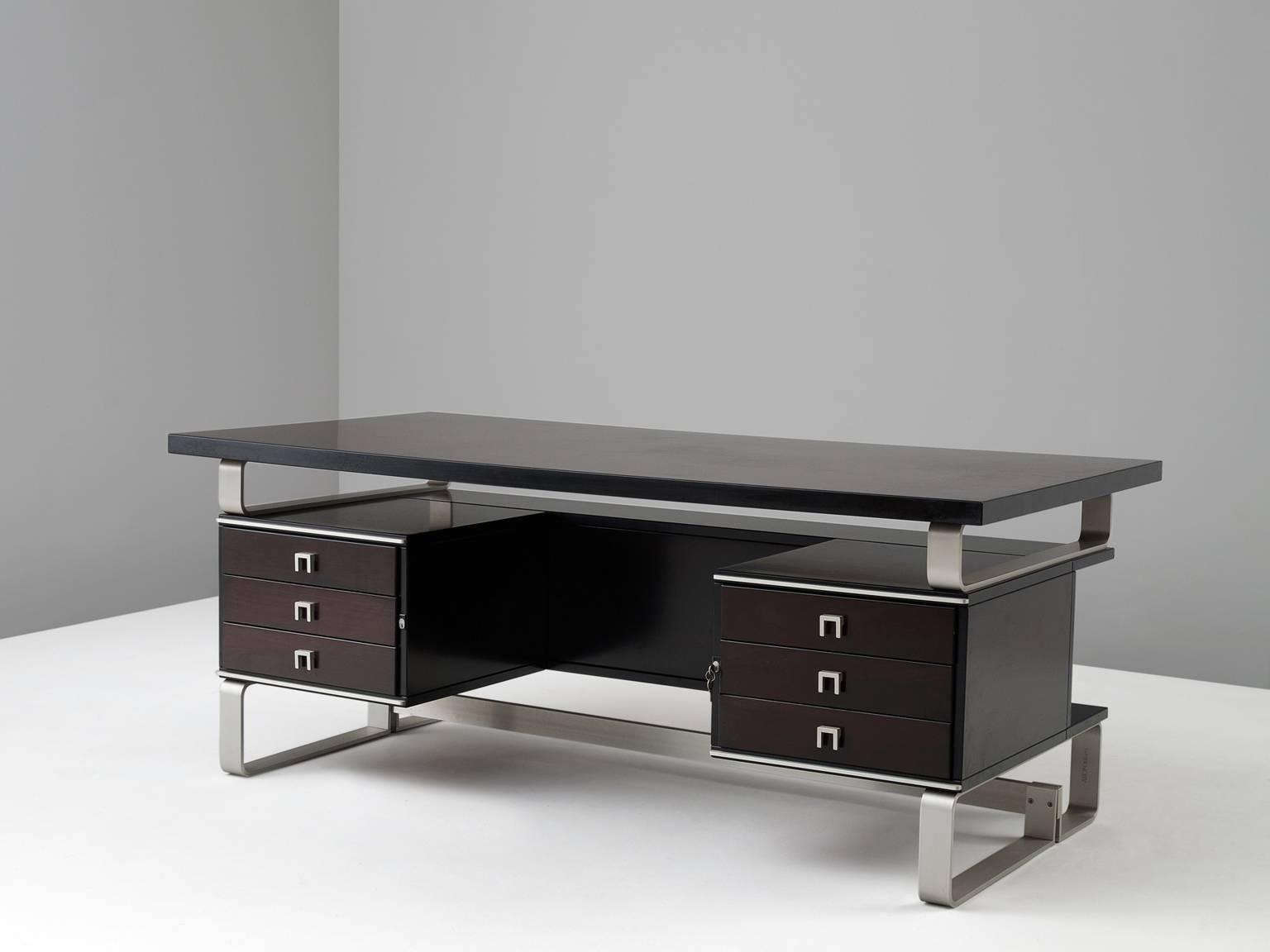 Desk, in mahogany and aluminium, for Abbondinterni,  Italy 1960s.

Italian desk. Frame from aluminium strips. Both sides of the desks are equipped with three drawers. Rectangular table top. The mahogany is stained in a dark brown/ruby color, which