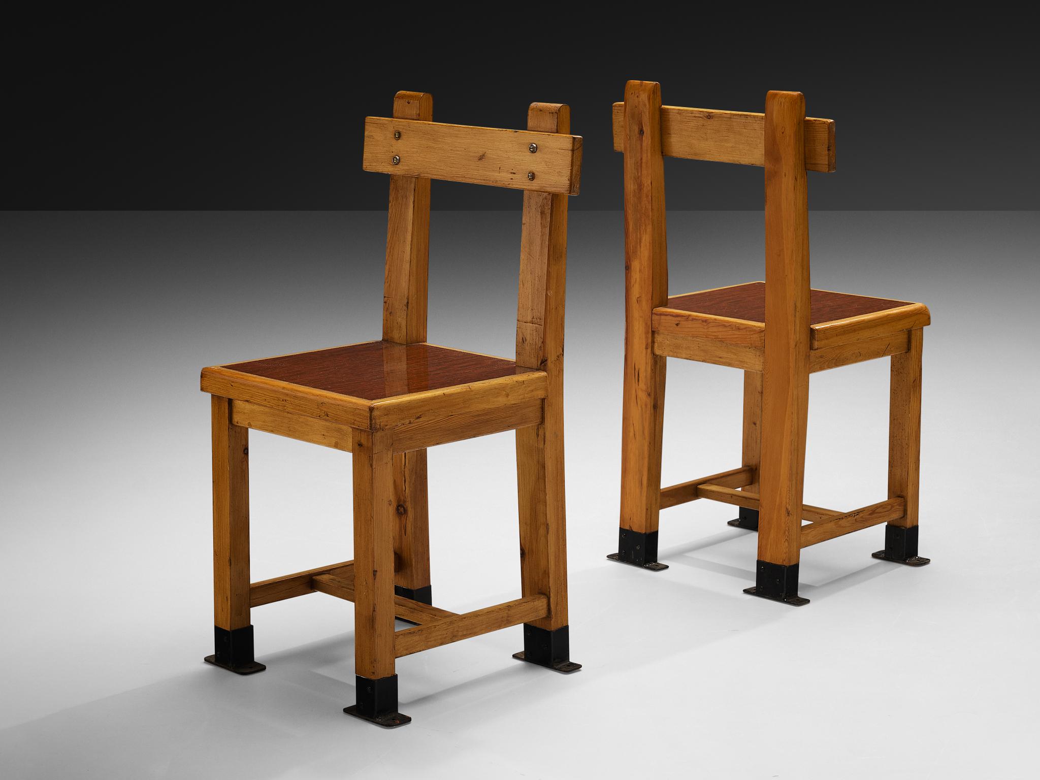 Pair of dining chairs, pine, metal, France, 1940s

This set of French dining chairs features a rather stunning design. Very strong and clean lines structure the chair in an admirable way. Characteristic are the black metal feet that fit within the