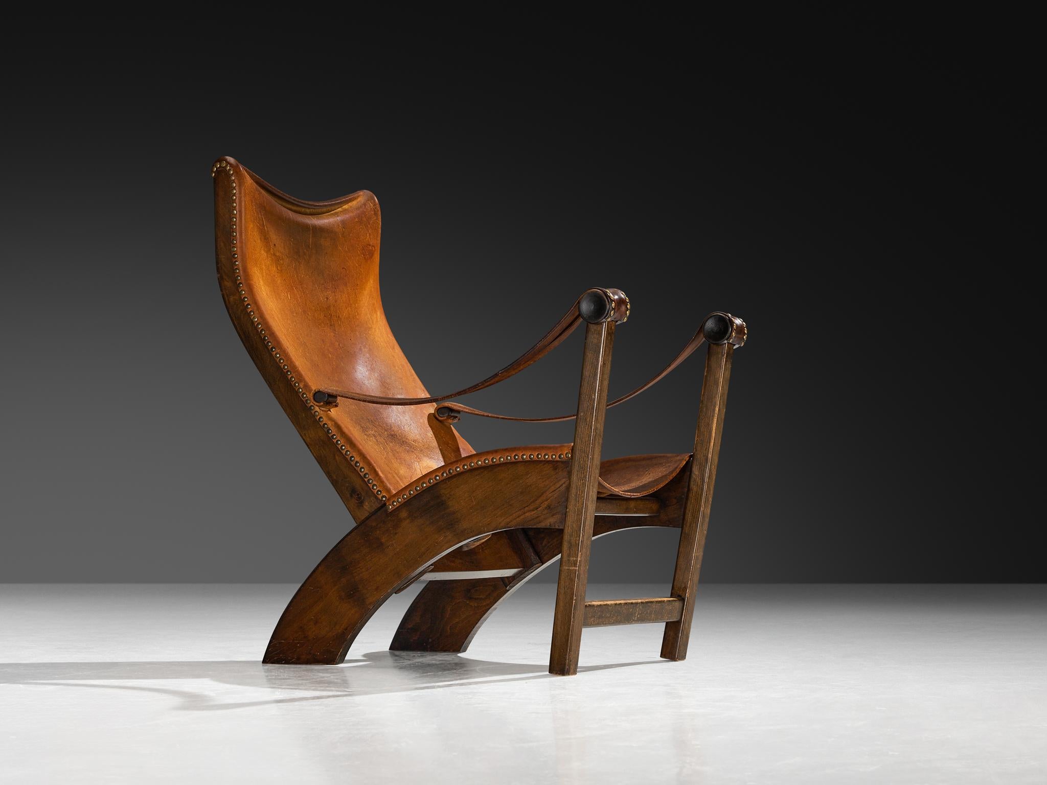 Mogens Voltelen für Niels Vodder, Sessel Modell 'Copenhagen', Buche, patiniertes Leder, Messing, Dänemark, Entwurf 1936, Ausführung 1940er Jahre

Der Loungesessel 