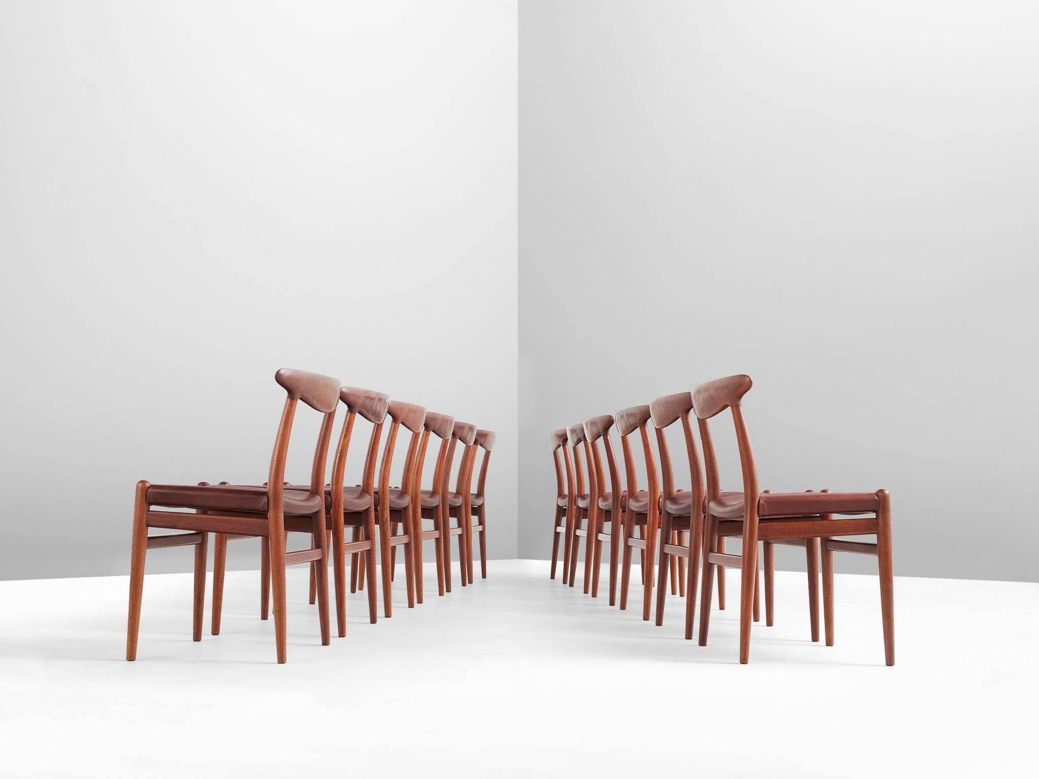 Set of 12 chairs model W2 in teak and leather by Hans J. Wegner, Denmark, 1950s.

Stunning set of 12 chairs by Danish designer Hans Wegner. Simplistic design for ergonomic and comfortable seating. All segments emphasize the open and light