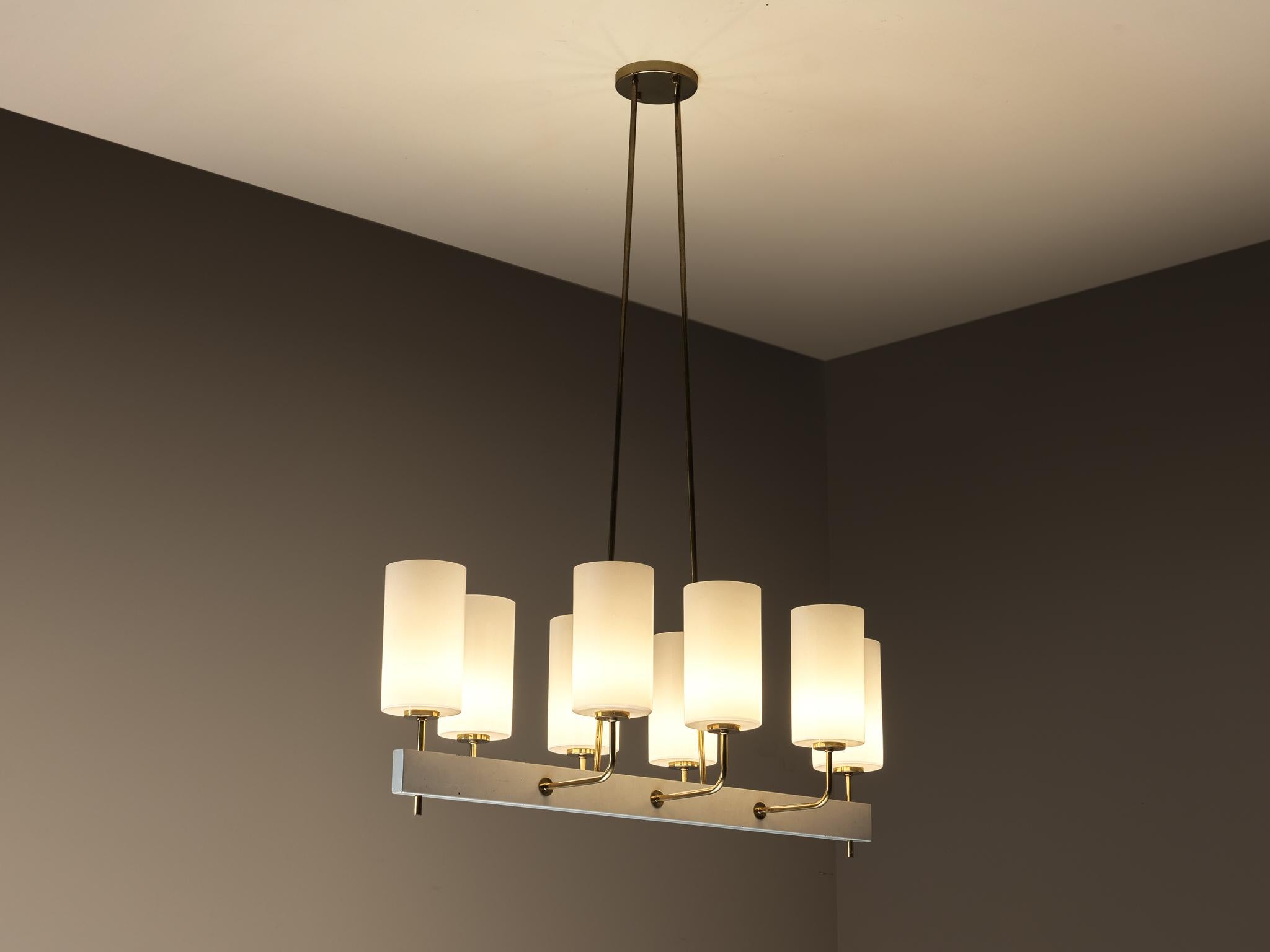Paavo Tynell for Idman, grand chandelier, lacquered steel, opal glass, brass, Finland, 1963

This substantial chandelier, measuring 155 cm/61.02 in. in width, is designed by the acclaimed Finnish design master Paavo Tynell, showcasing a clear study