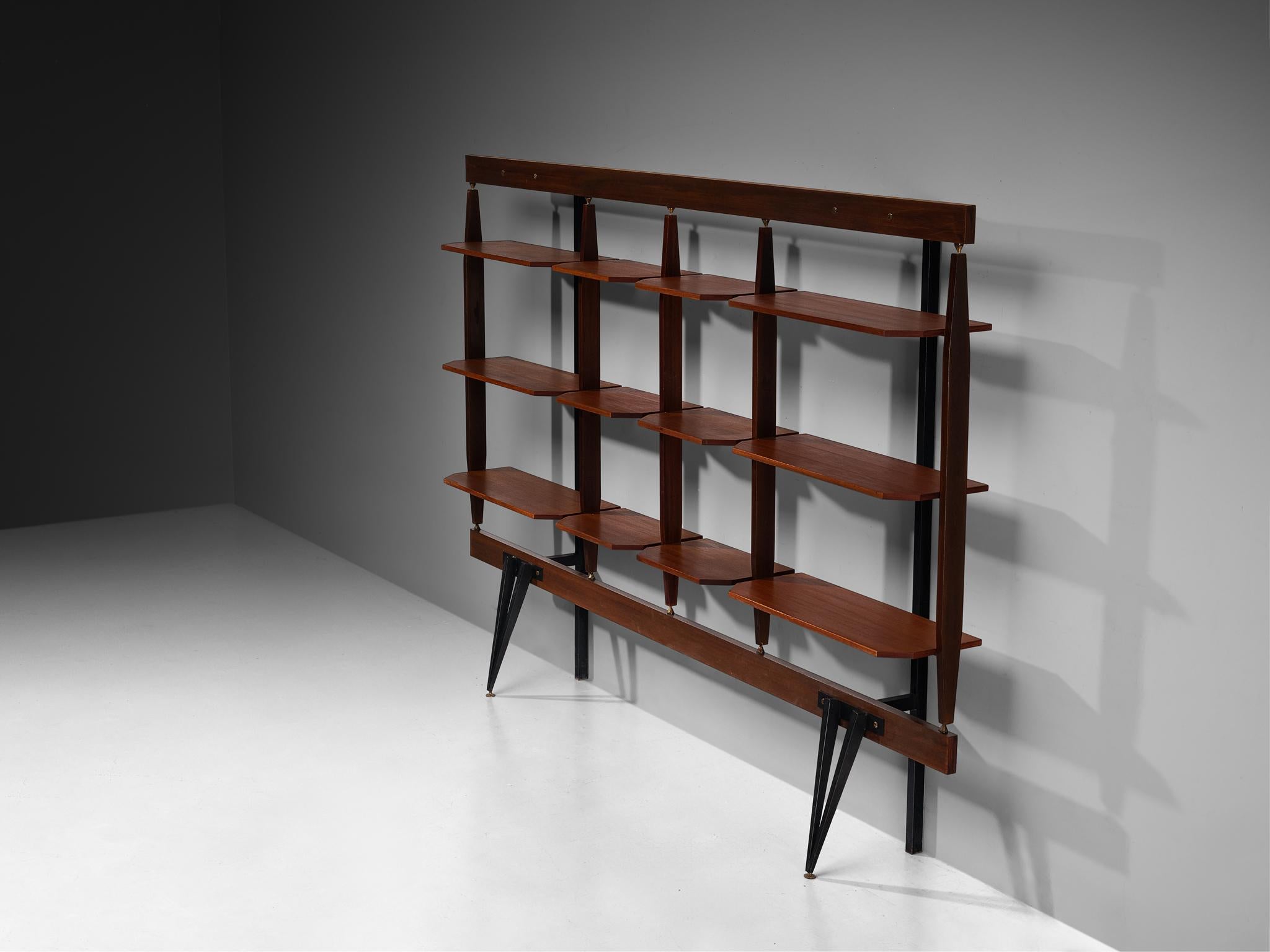 Wall unit, brass, steel, teak, Italy, 1940s

This Italian wall unit, crafted at the end of the 1940s, is a refined example of midcentury design, seamlessly blending form and function. Executed in warm teak, complemented by brass accents and sturdy