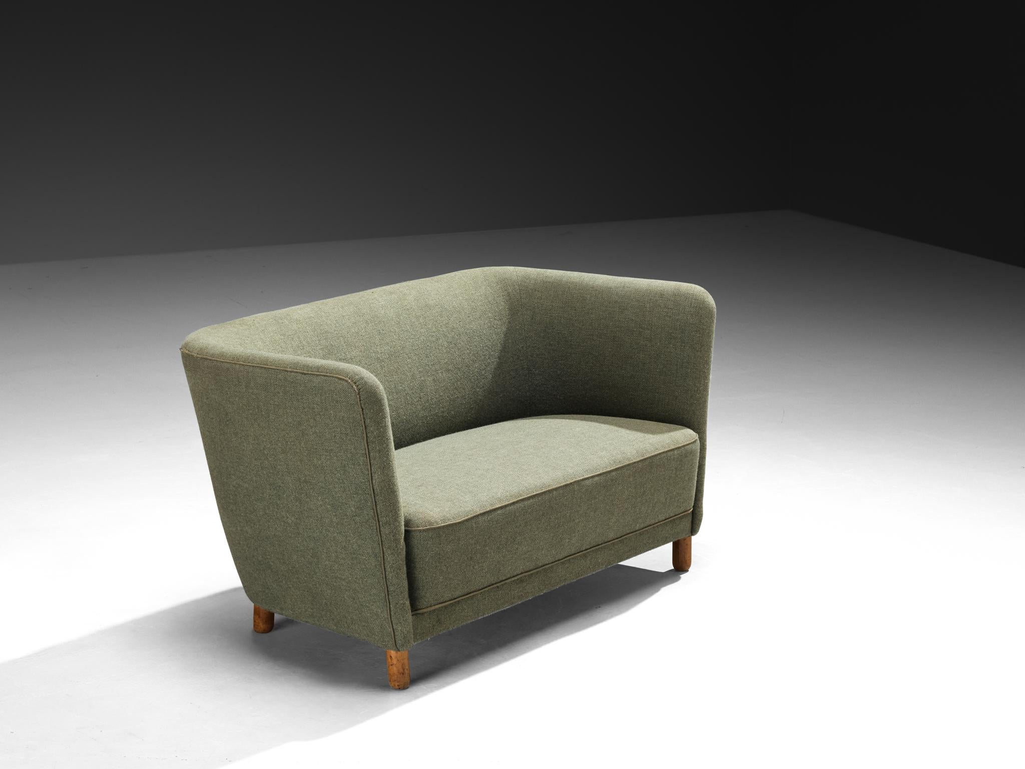 Sofa, wool, beech, Scandinavia, 1950s

This Scandinavian-modern sofa from the 1950s embodies a quiet elegance rooted in the design language of mid-century Northern Europe. The sofa’s shape is both compact and sculptural. The back curves gently
