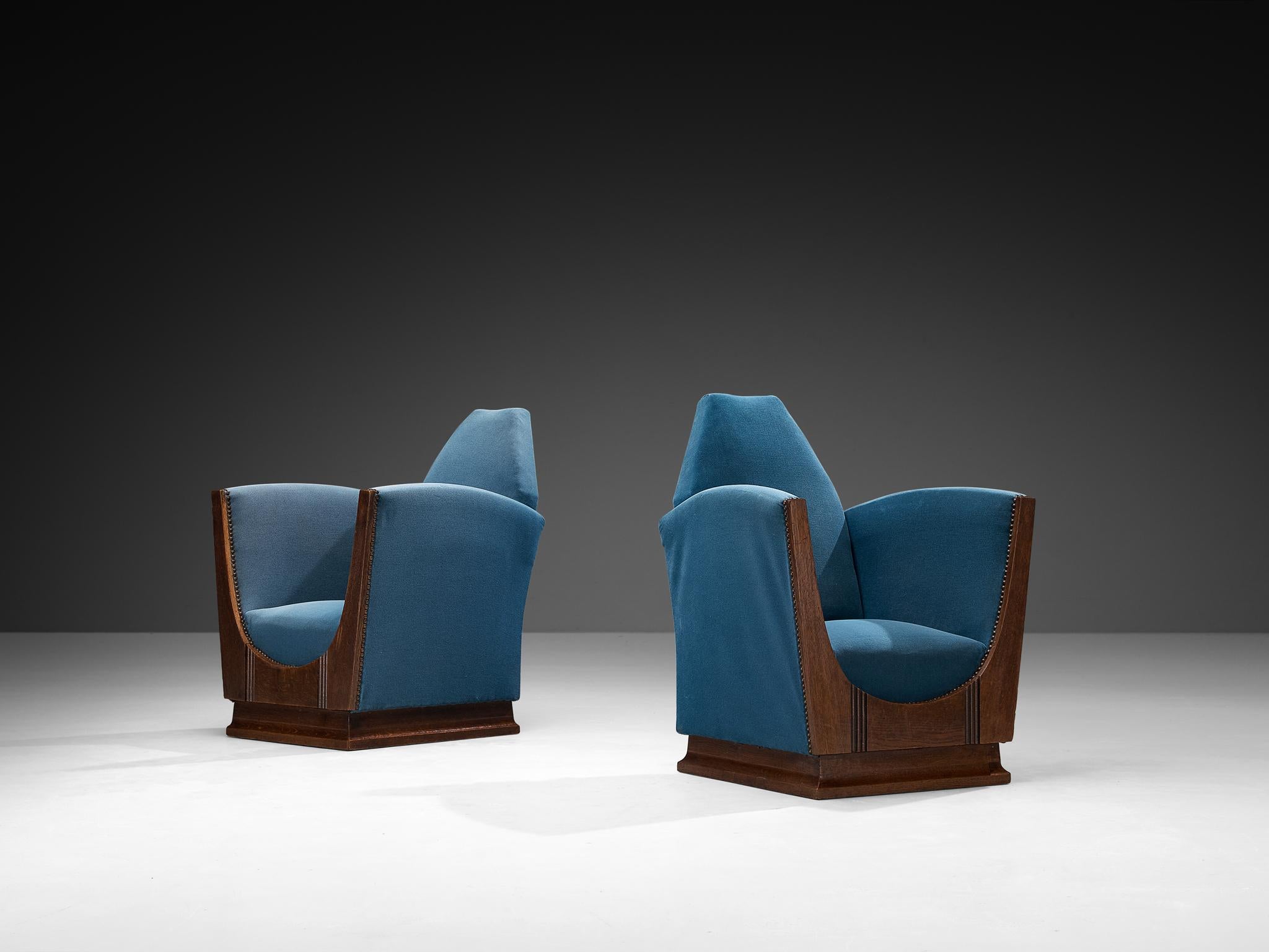 Pair of lounge chairs, velvet, oak, metal, France, 1920s

These 1920s French armchairs are striking examples of the Art Deco movement, but they also carry a strong undercurrent of the Amsterdamse School, especially in their sculptural quality and