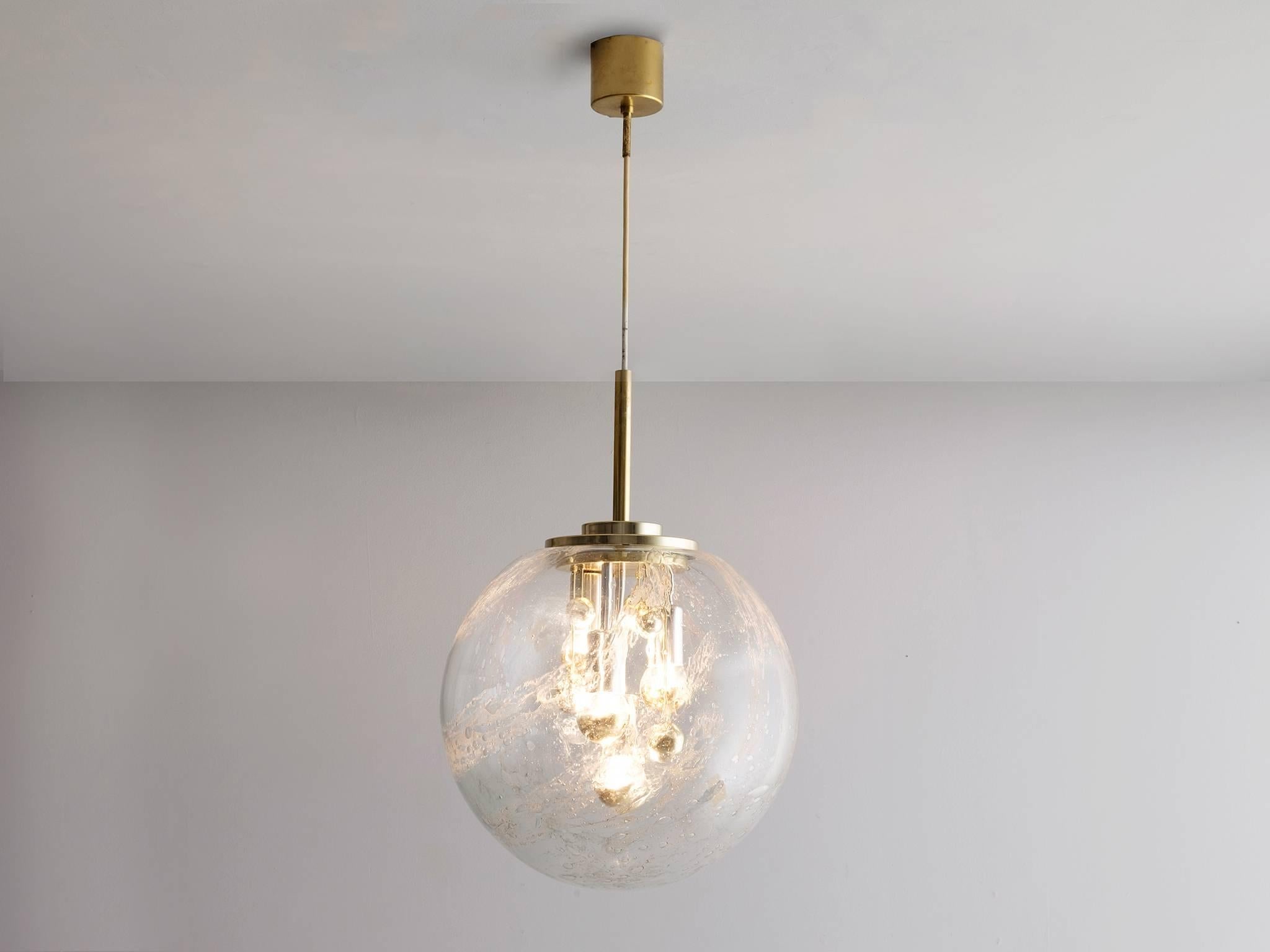 Pendant, in glass and brass, European, 1970s.

Wonderful pendant in brass. This large glass sphere has a fixture with four light-points. In addition of glass decorations inside the sphere, this light creates a stunning light partition. Due the