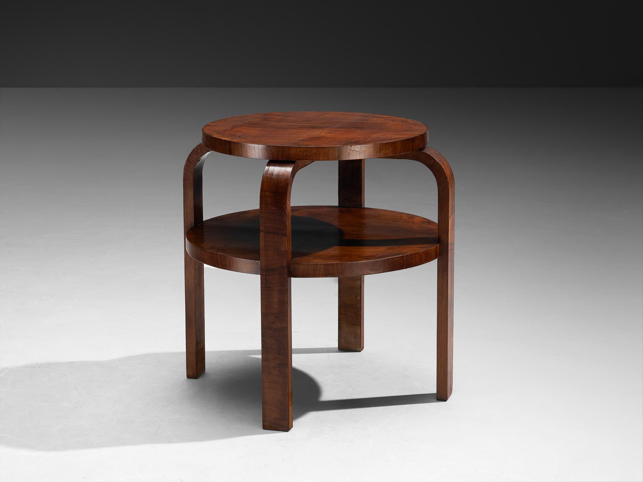 Side table, walnut veneer, Italy, 1930s

This round side table is a great example of Italian Art Deco design from the 1930s. It’s made with a warm walnut veneer that gives it a opulent yet natural look. The table shows two levels, offering extra