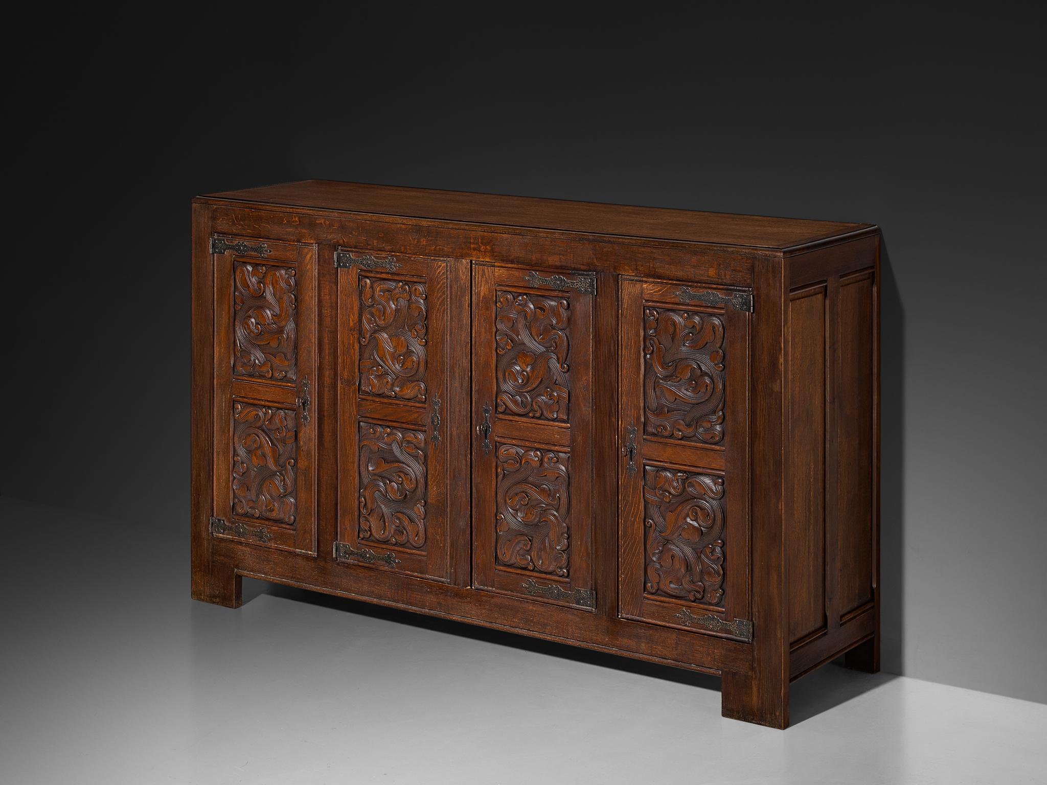 Joseph Savina, sideboard, oak, wrought iron, France, 1950s

Designed by the Frenchman Joseph Savina, this cabinet is a testament to exquisite craftsmanship and profound artistry. The corpus is solidly built marked by distinct geometrical elements