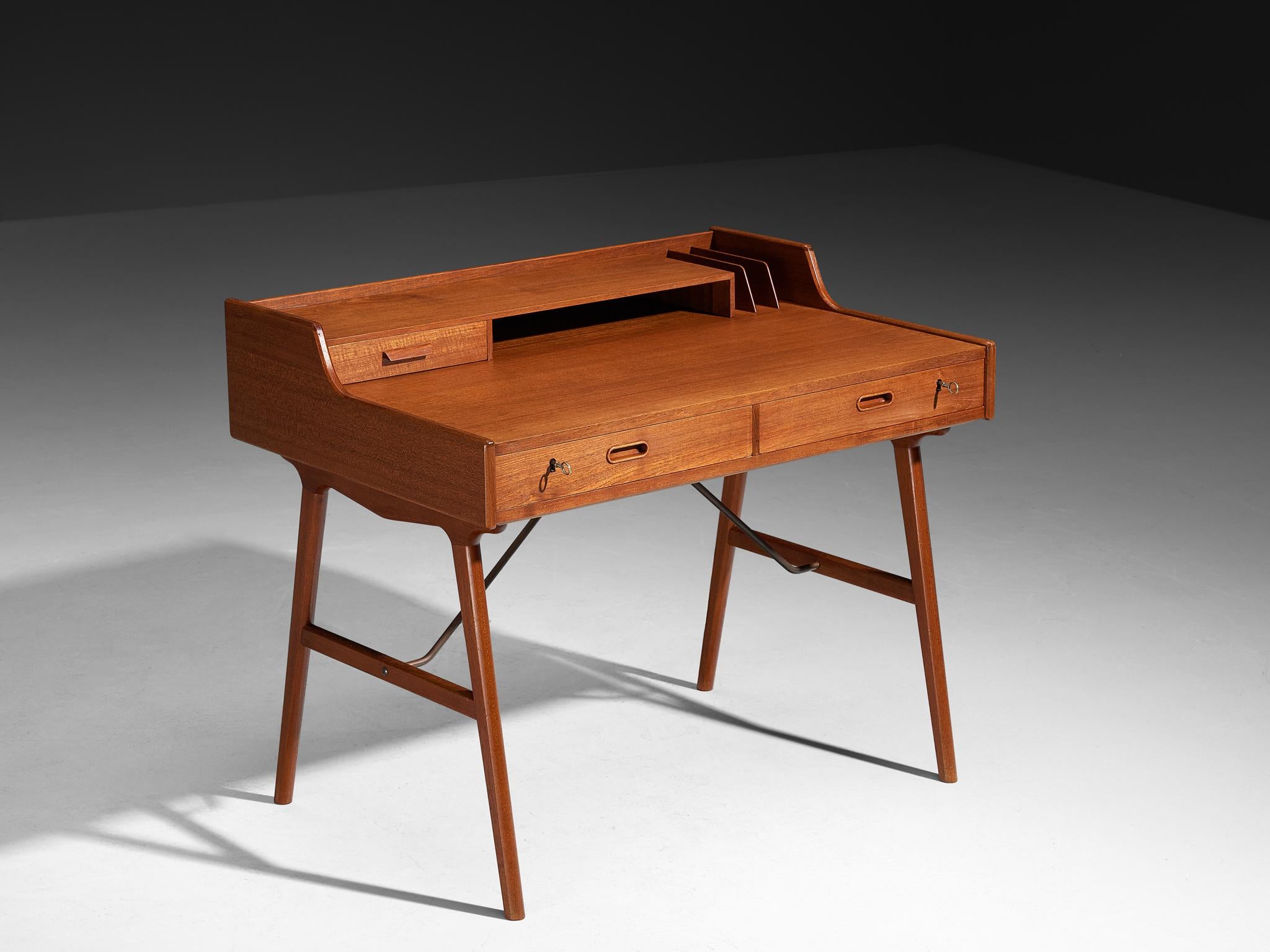 Arne Wahl Iversen for Vinde Møbelfabrik, desk, model 65, teak, brass, Denmark, 1961.

The refined model 65 desk by esteemed Danish designer Arne Wahl Iversen. This elegant writing table exudes sophistication with its high cylindrical legs, creating