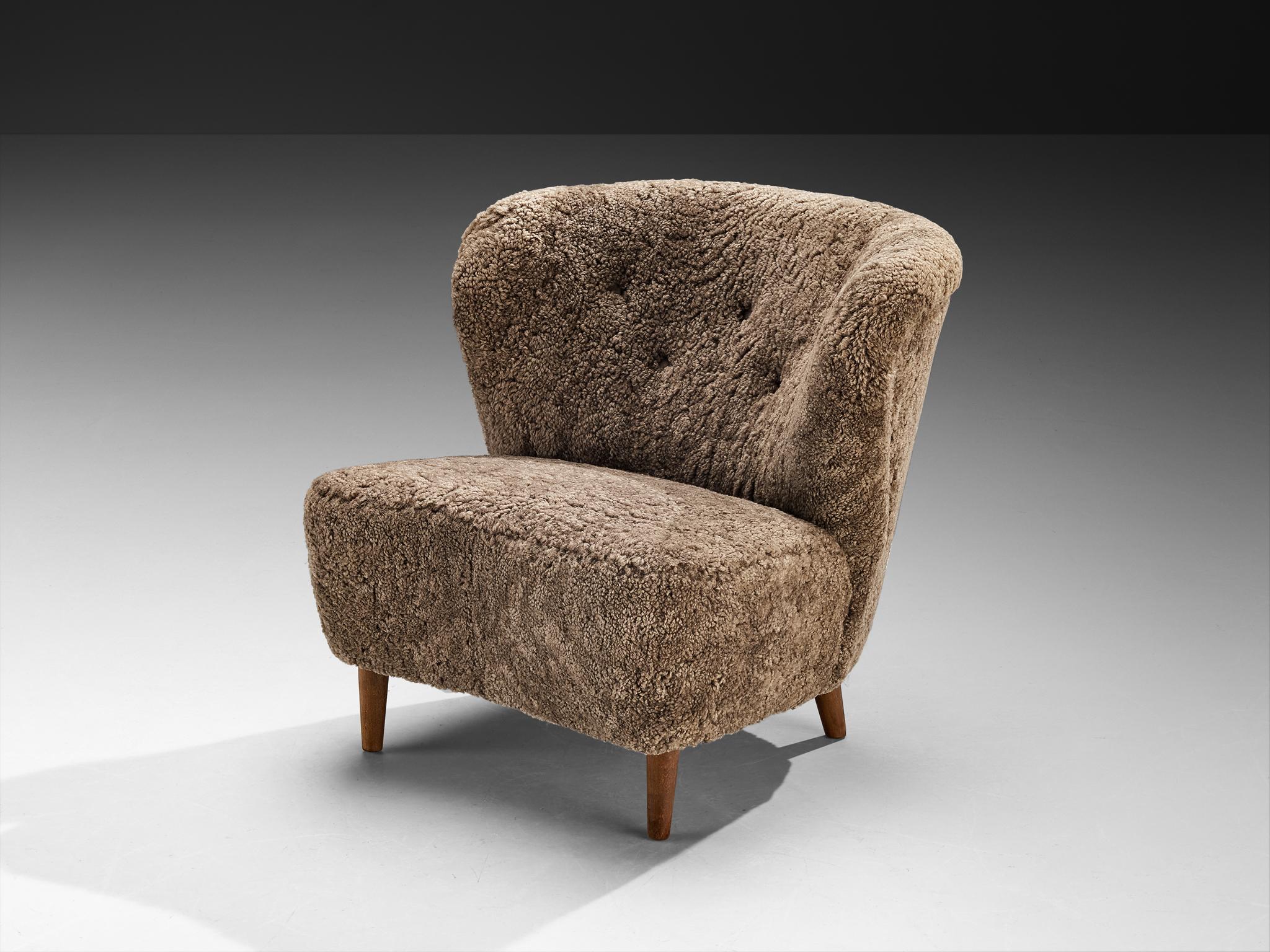 Gösta Jonsson, chaise longue, hêtre, peau de mouton, Danemark, années 1940 

Cette charmante chaise longue de Gösta Jonsson s'éloigne de la rigidité géométrique et adopte plutôt une qualité sculpturale douce qui semble à la fois organique et