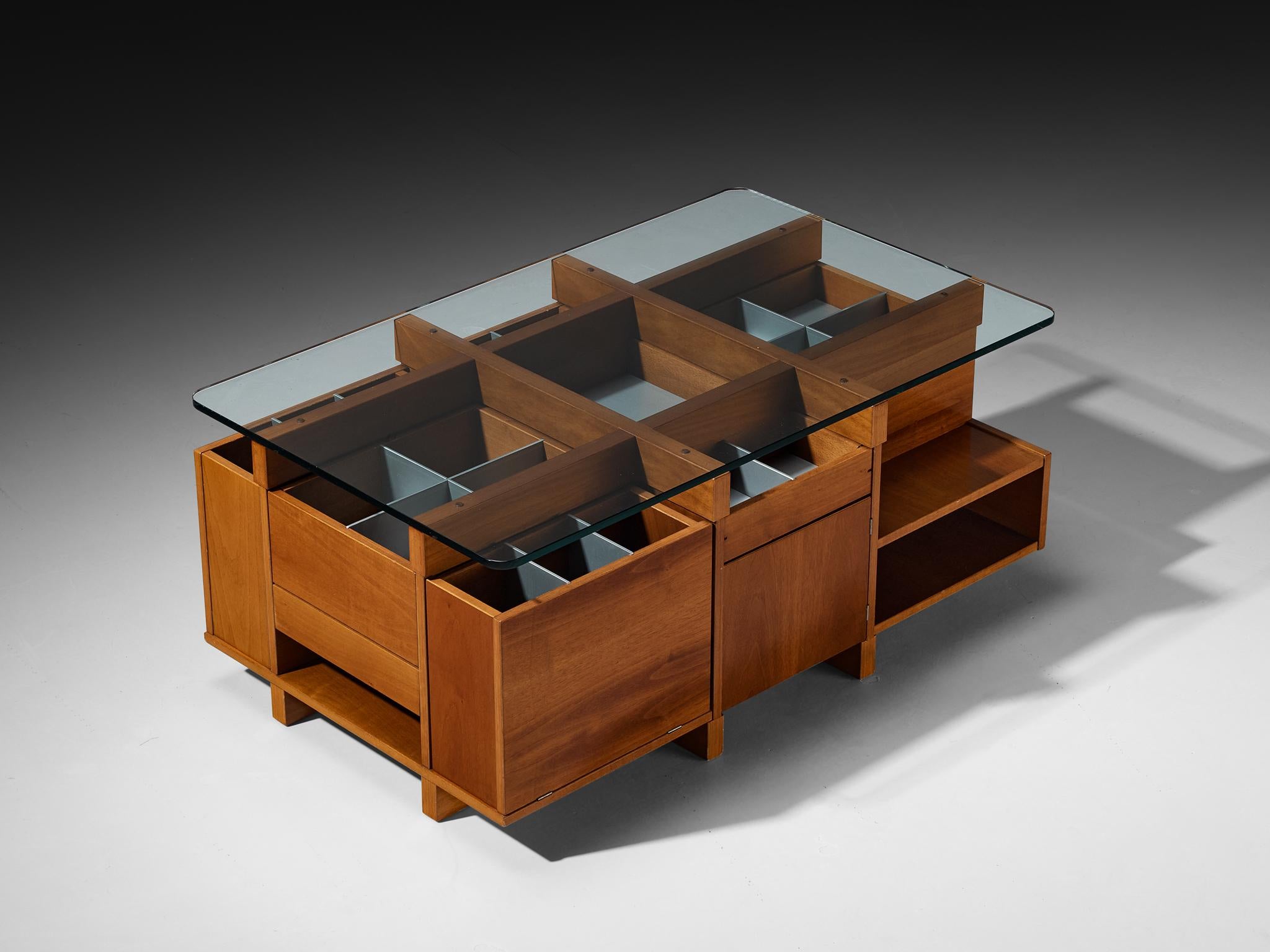 Coffee table, walnut, lacquered wood, glass, Italy, 1970s 

This 1970s Italian coffee table is a geometric and highly organized composition, built from walnut, glass, and grey lacquered inserts. The form presents itself as a rectilinear grid,