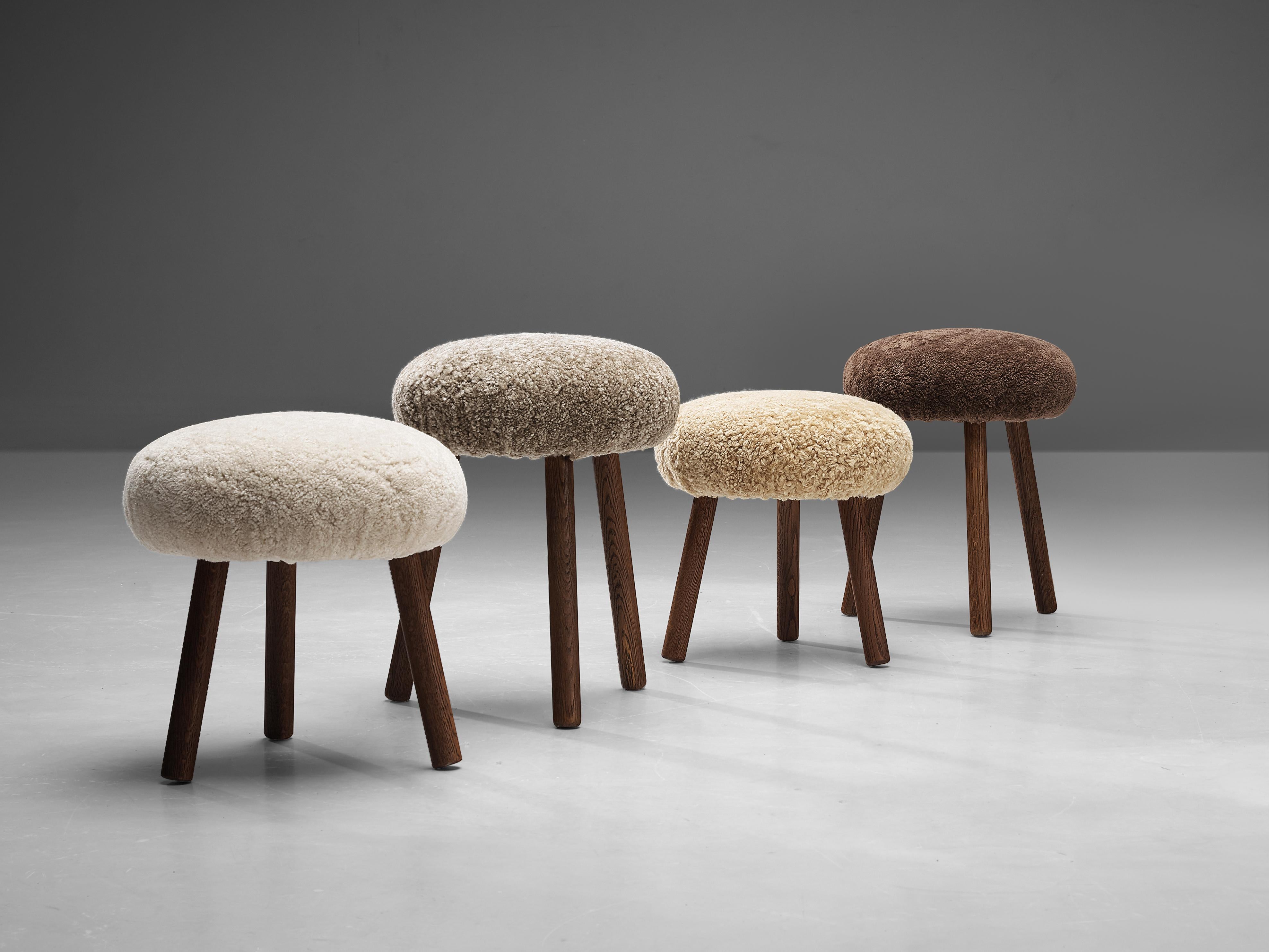 Tripod stools or side tables, solid oak, shearling, Switzerland, 1960s-1970s.

Beautiful crafted oak stools originating from the exhibition center in St. Gallen, Switzerland. Each stool is composed of two main elements: a generously upholstered,