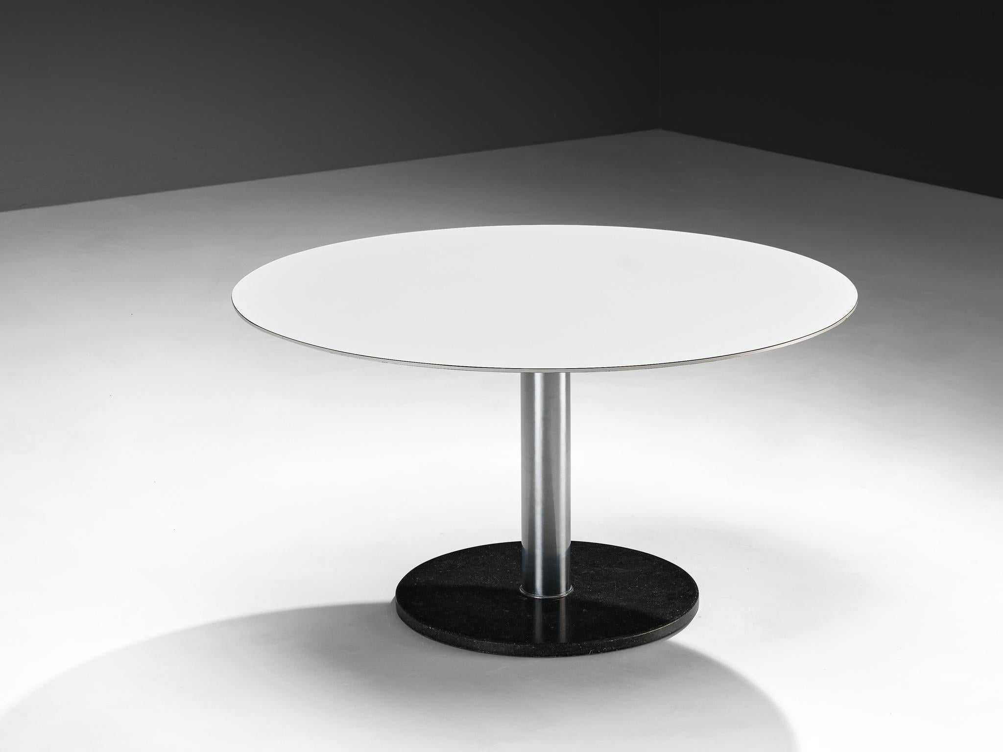 Round table, stone, laminated wood, chromed metal, Europe, 1960s

Made in Europe in the 1970s, this round table features a minimalist design with a strong material presence. The base is crafted from dark colored solid stone, providing a grounded