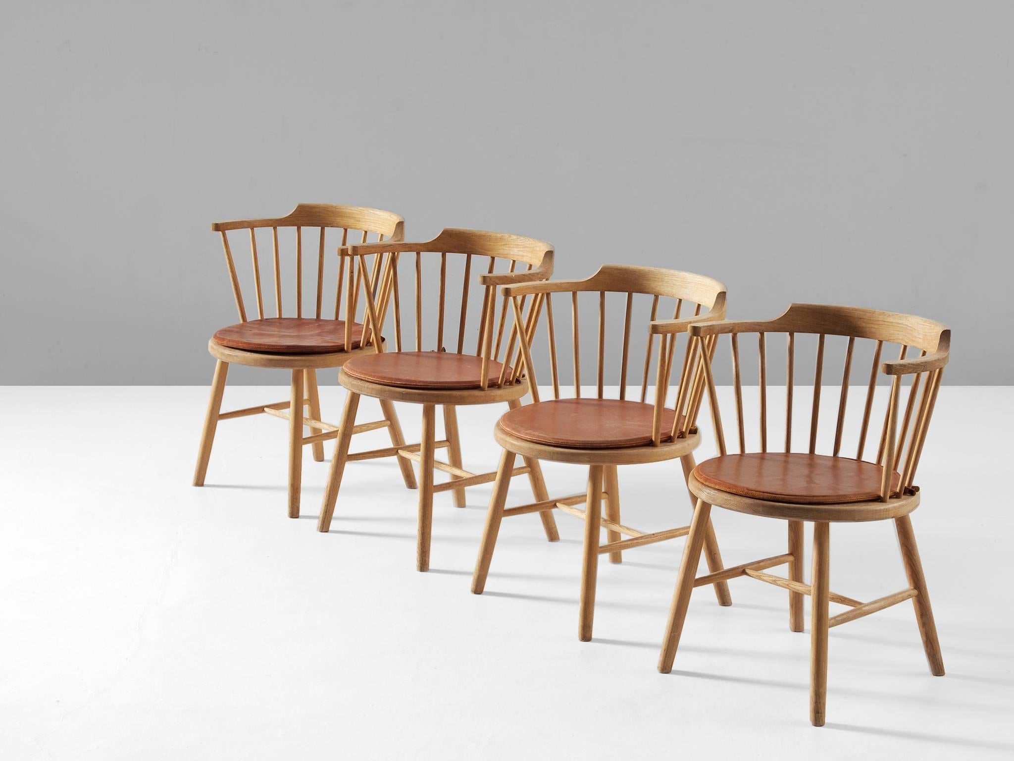 Set of four dining chairs model 3249, in oak, by Børge Mogensen for Fredericia Stolefabrik, Denmark, 1944. 

Set of four 'Captain chairs' with a spindle back and armrests. Elegant yet simplistic chairs with a beautiful spoke back. Repetitive form