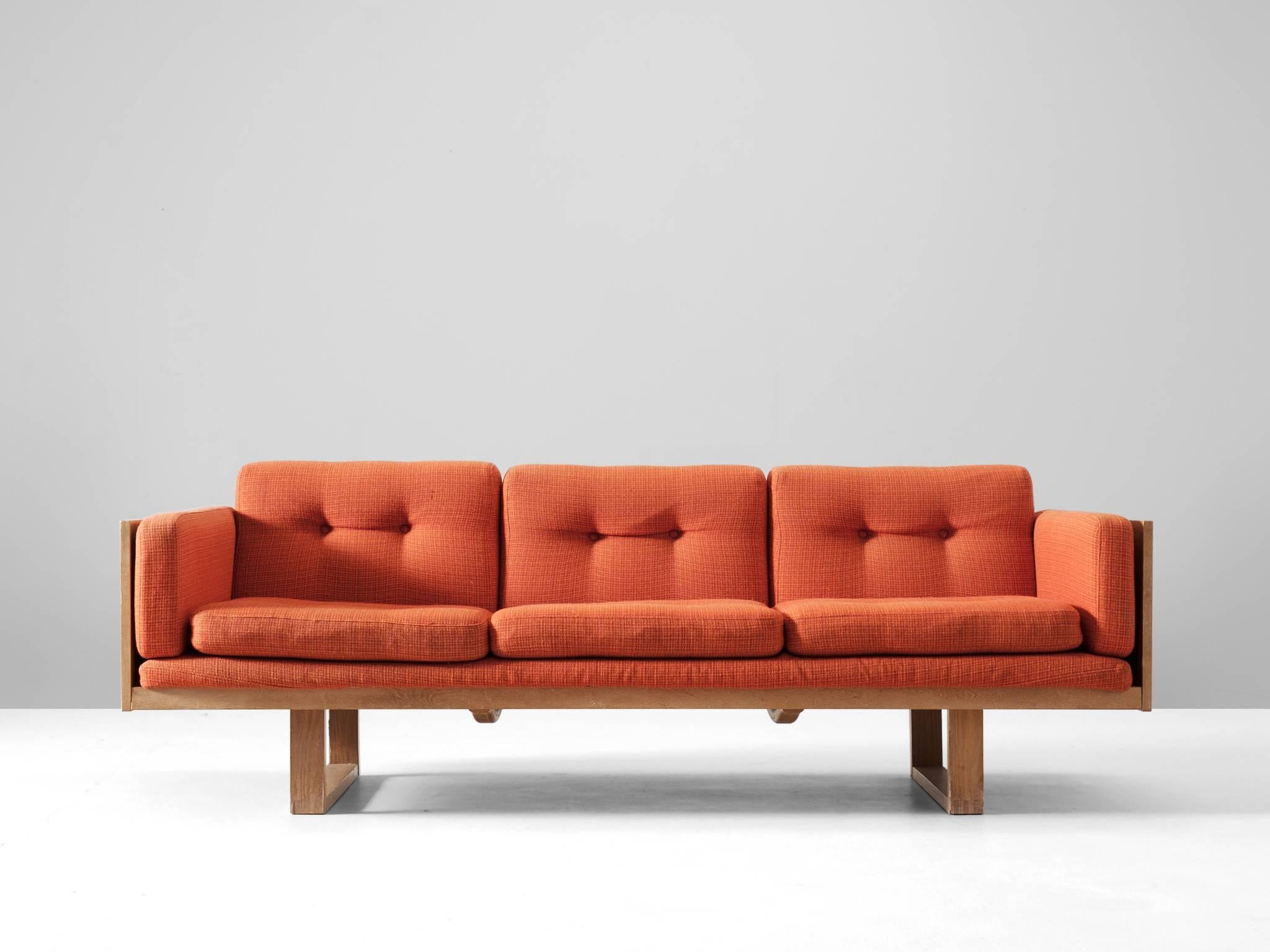 Three-seat sofa, in oak and fabric, by Poul Cadovius for France & Søn, Denmark, 1960s. 

Three seater sofa by Danish designer Poul Cadovius. The frame consist of oak. Two sled legs provide an open look to the more closed sofa. All sides are
