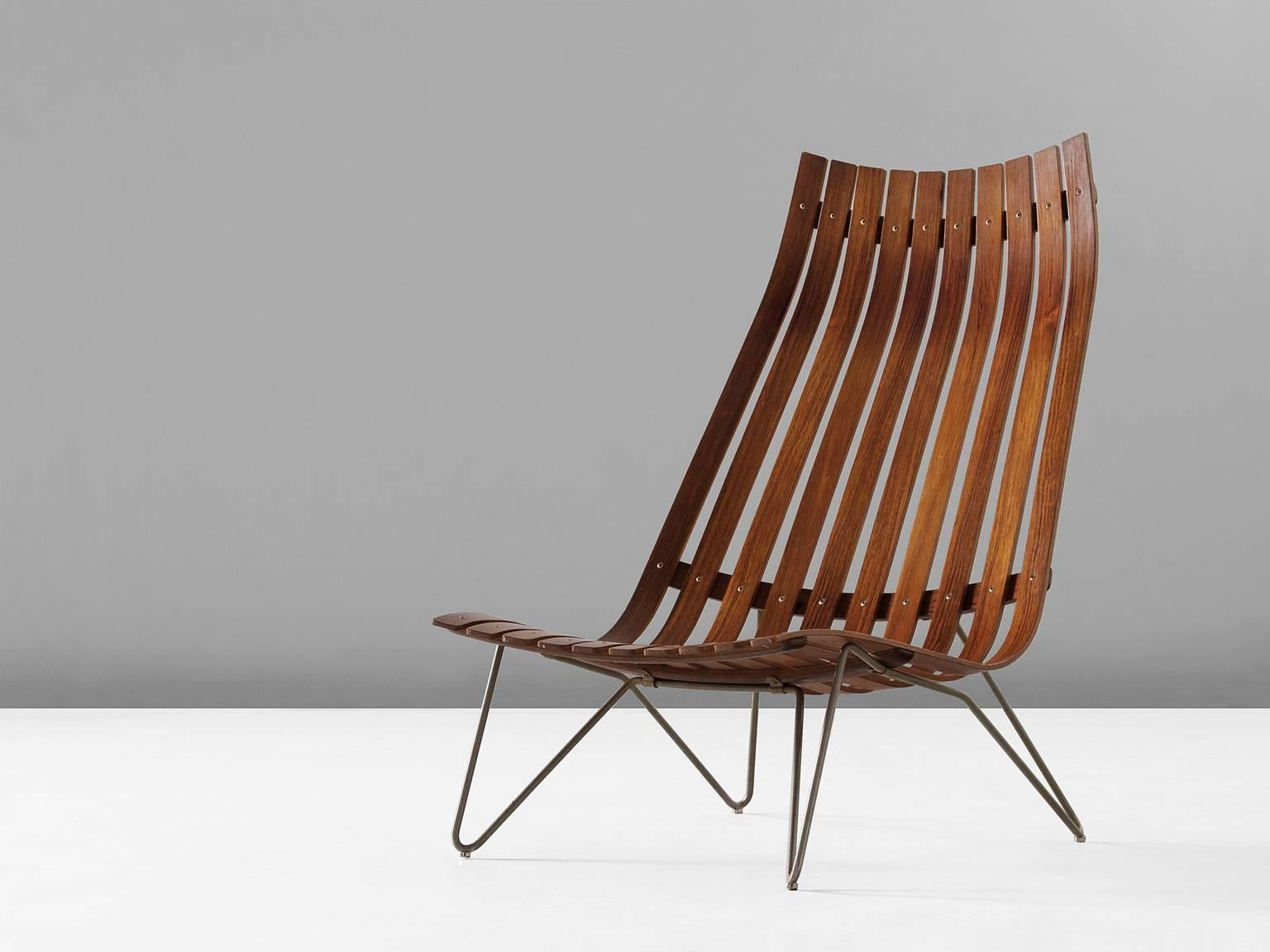 Lounge chair model Scandia, in rosewood and metal, by Hans Brattrud for Hove Mobler, Norway, circa 1957. 

Elegant and modern lounge chair in warm rosewood. This slatted chair shows an interesting 'hairpin' frame of one piece of bended metal. The