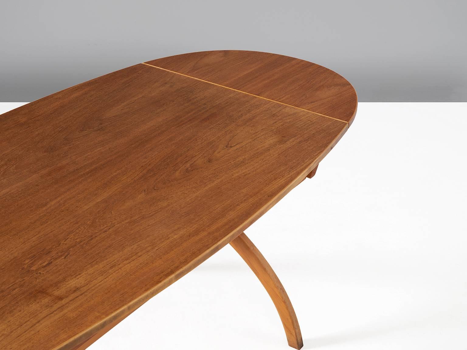 Desk, in teak and beech, by Børge Mogensen, Denmark, 1960s. 

Oval shaped drop-leaf table by Danish Designer Børge Mogensen. The table consist of an X-shaped base with two legs and an oval top with drop-leafs. Under the top are two drawers. This