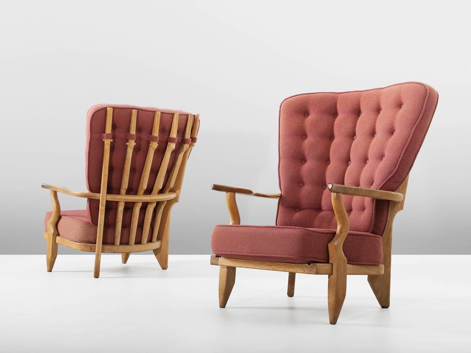 Pair of lounge chairs, in oak and fabric, by Guillerme et Chambron, France, 1960s.

Set of two extraordinary Guillerme & Chambron high back lounge chairs, in solid oak with the typical characteristic decorative details at the back and capricious