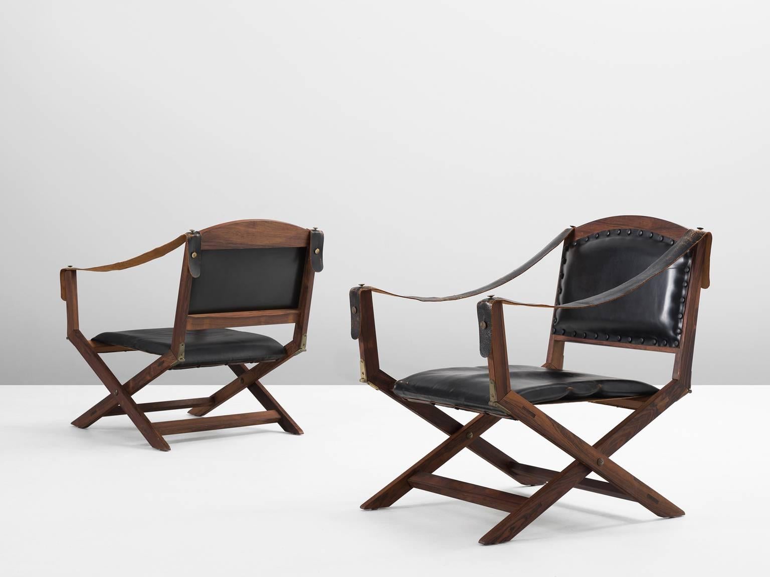 Set of two armchairs, in rosewood and leather, Scandinavia, 1940s. 

Two foldable safari chairs in Indian rosewood and black leather upholstery. These X-chairs have a classical appearance with several references to ancient furniture. These Campaign