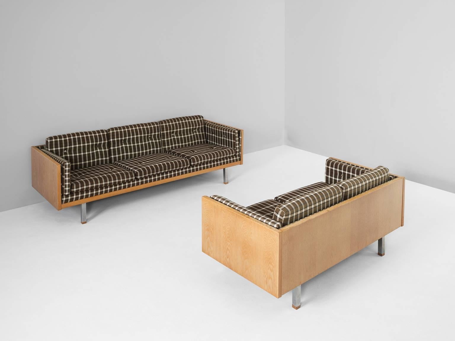 Three and two-seat sofa, in oak, metal and fabric, Denmark, 1960s.

Scandinavian living room set, a two and three-seat sofa. The frame consist of oak with cubic metal legs, which provide an open look to the quite solid seating of the sofa's. All