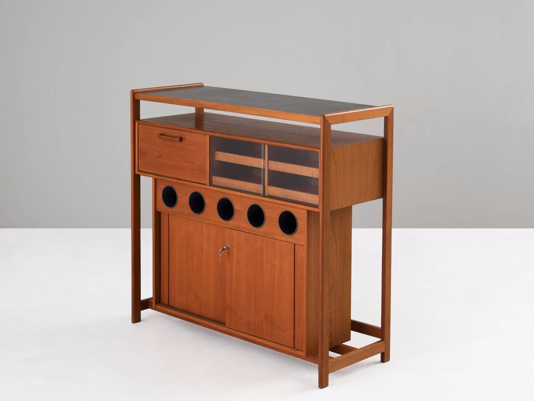 Bar, in teak, glass and wood, Denmark, 1960s.

Refined dry bar in teak. This bar is well designed with clever storage facilities. The design is simplistic. The several storage compartments are placed in a wooden frame, this gives the design an