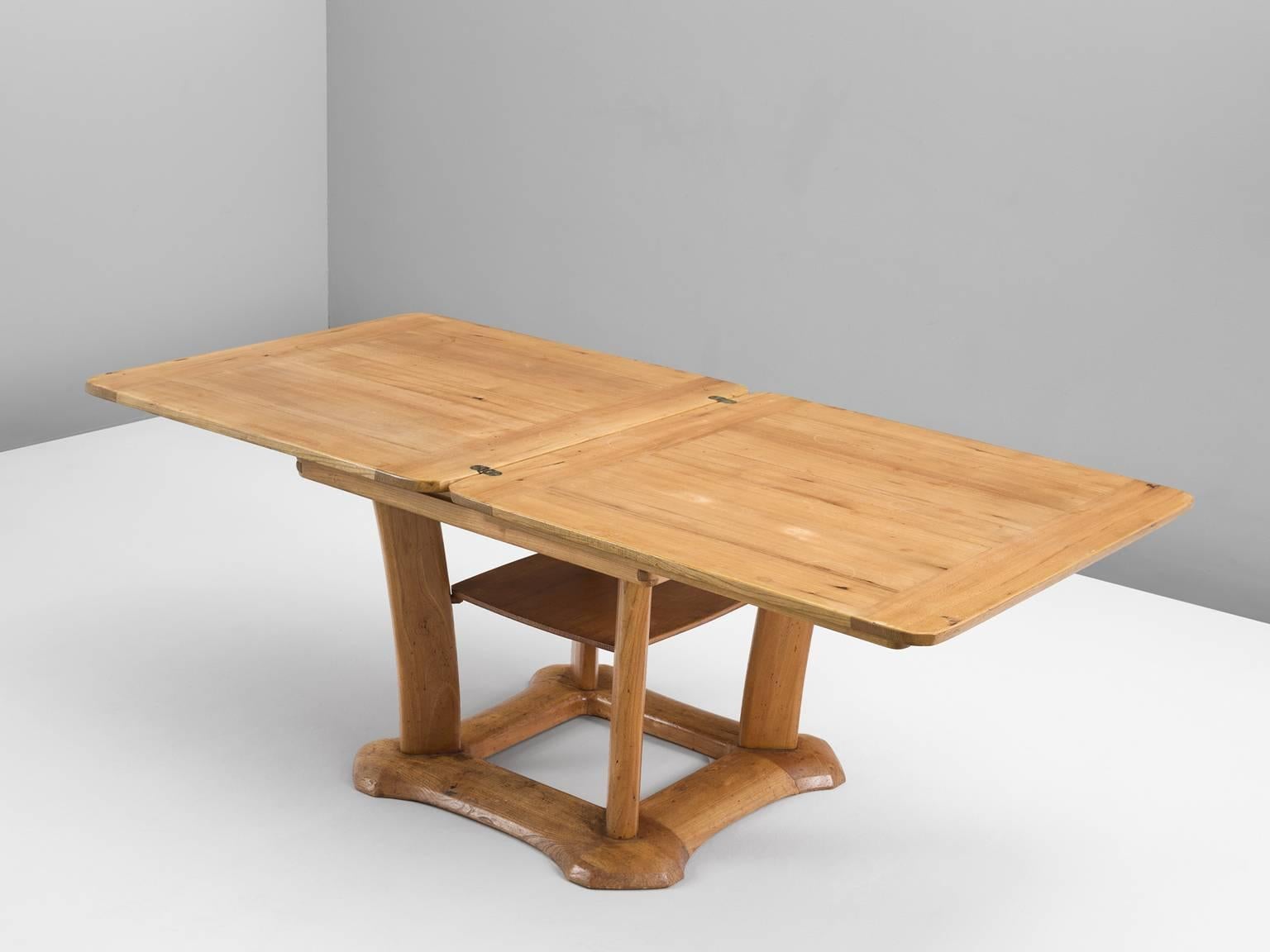 Dining table, in elm, by Franz Xavier Sproll, Switzerland 1940s. 

Interesting center table in elmwood. This extendable table consist of an architectural square base, which is beautifully detailed with it's rounded edges. The square top can be