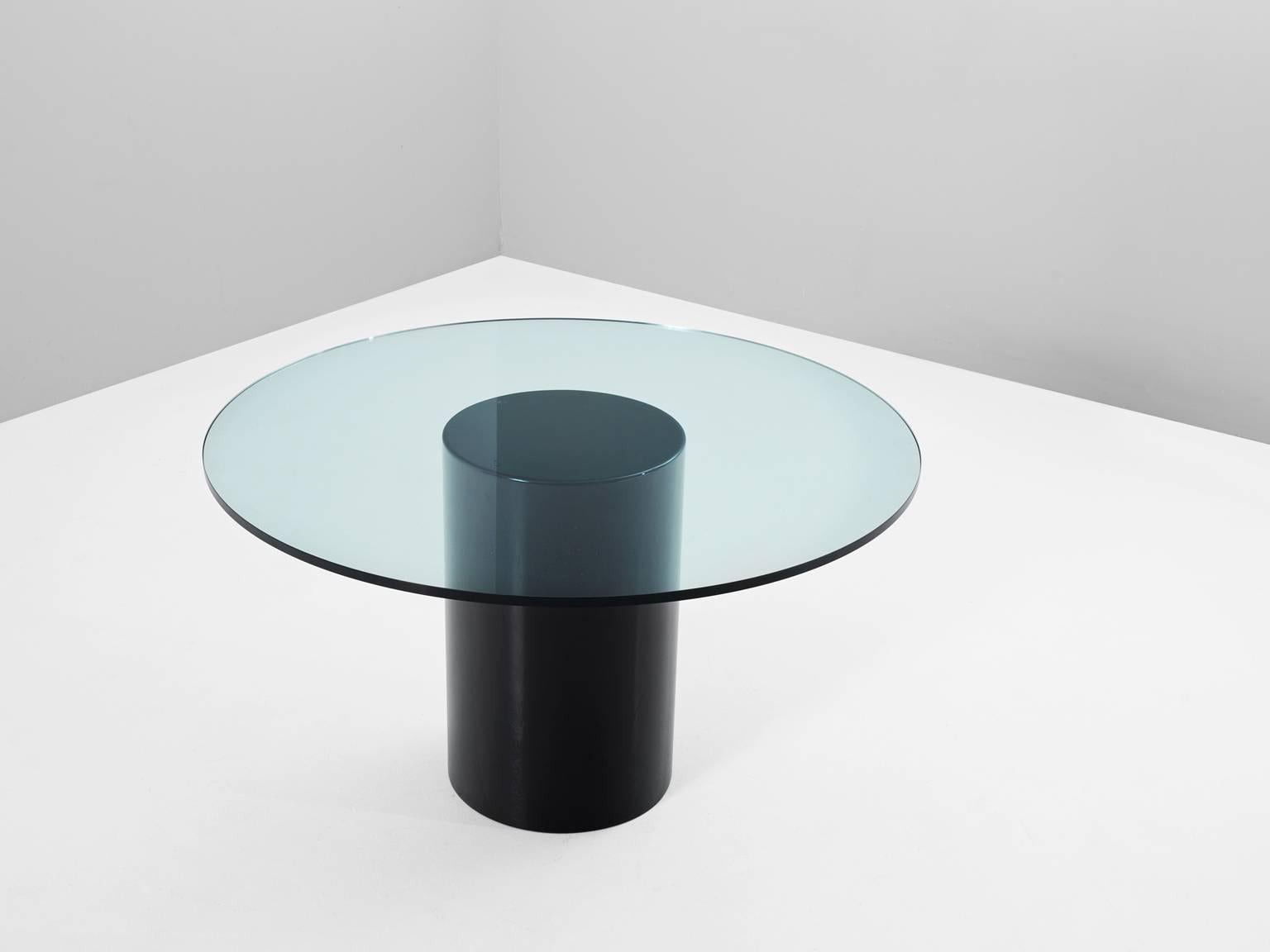 Dining table, in wood and glass, Italy, 1960s.

Mid-Century dining table with round clear glass top. The design of this table is simplistic. A wide round column as base, lacquered in black. The table's top is round and consist of clear glass.
