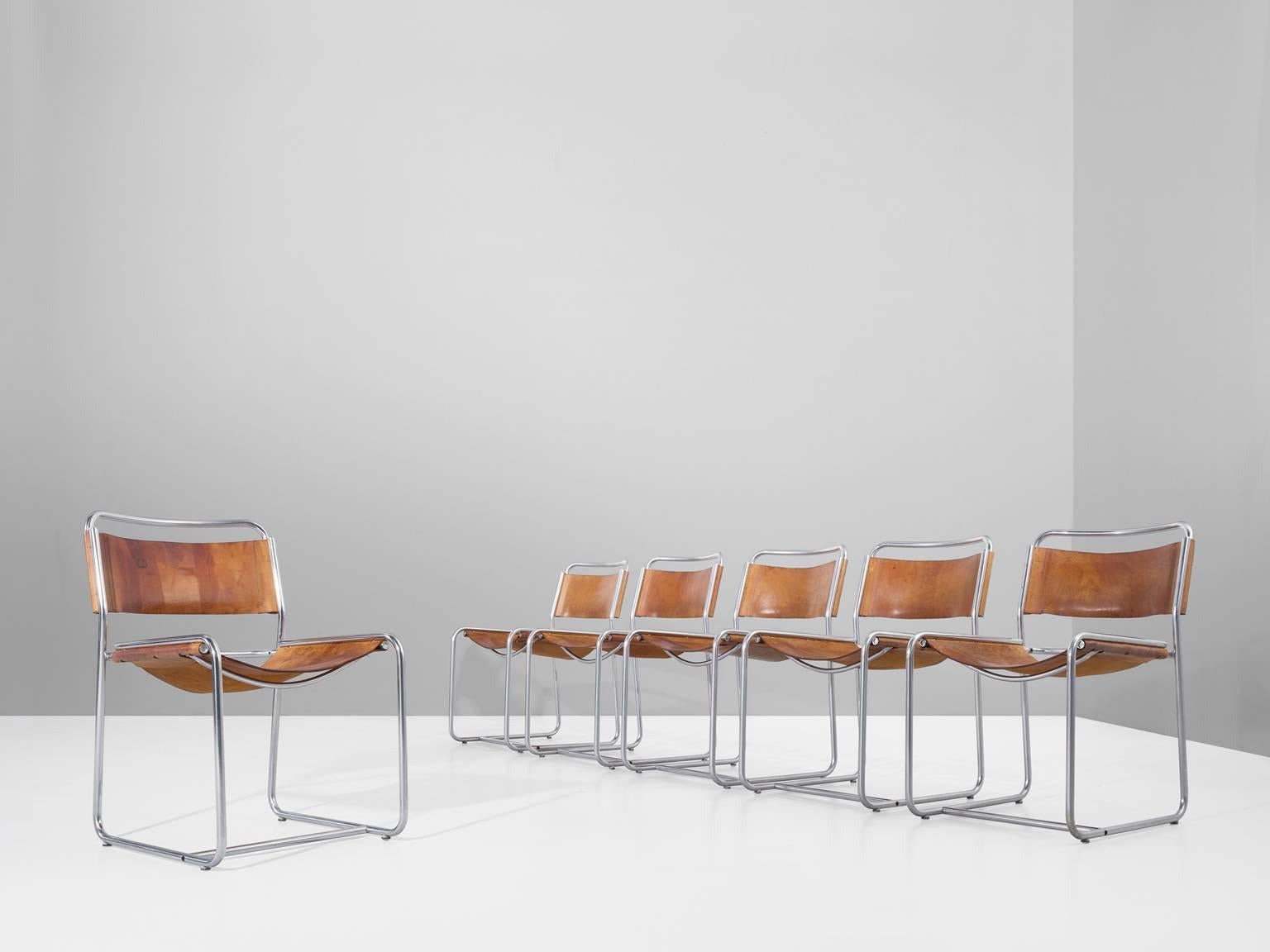 Set of six dining chairs, in metal and leather, by Clair Bataille and Paul Ibens for 't Spectrum, the Netherlands 1971. 

Set of six tubular chairs with natural saddle leather seating and back. The frame consists of thin tubular steel formed into a