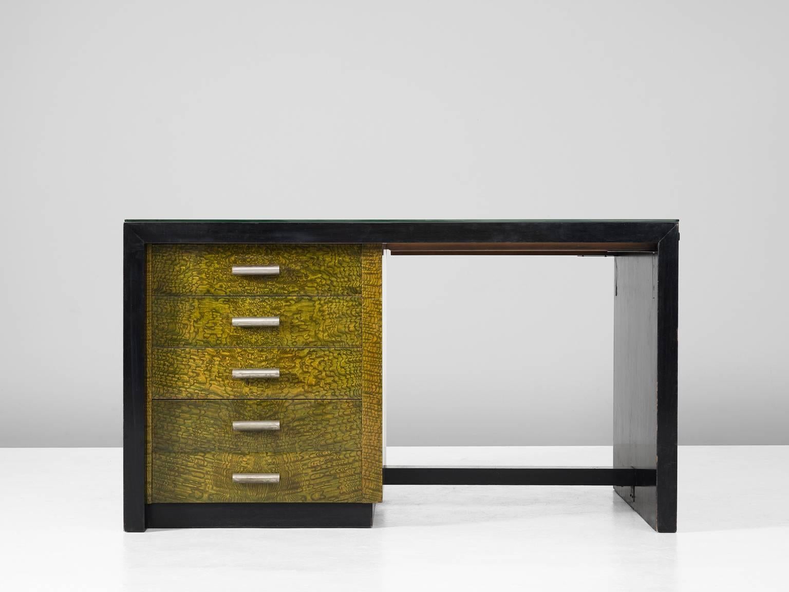 Desk, in wood, metal and glass, Europe, 1930s.

Highly rare desk from the late Art Deco era. The design is cubic and straight, in black lacquered wood. Equipped with a drawer unit and extendable top. The compartment of the drawers is executed in