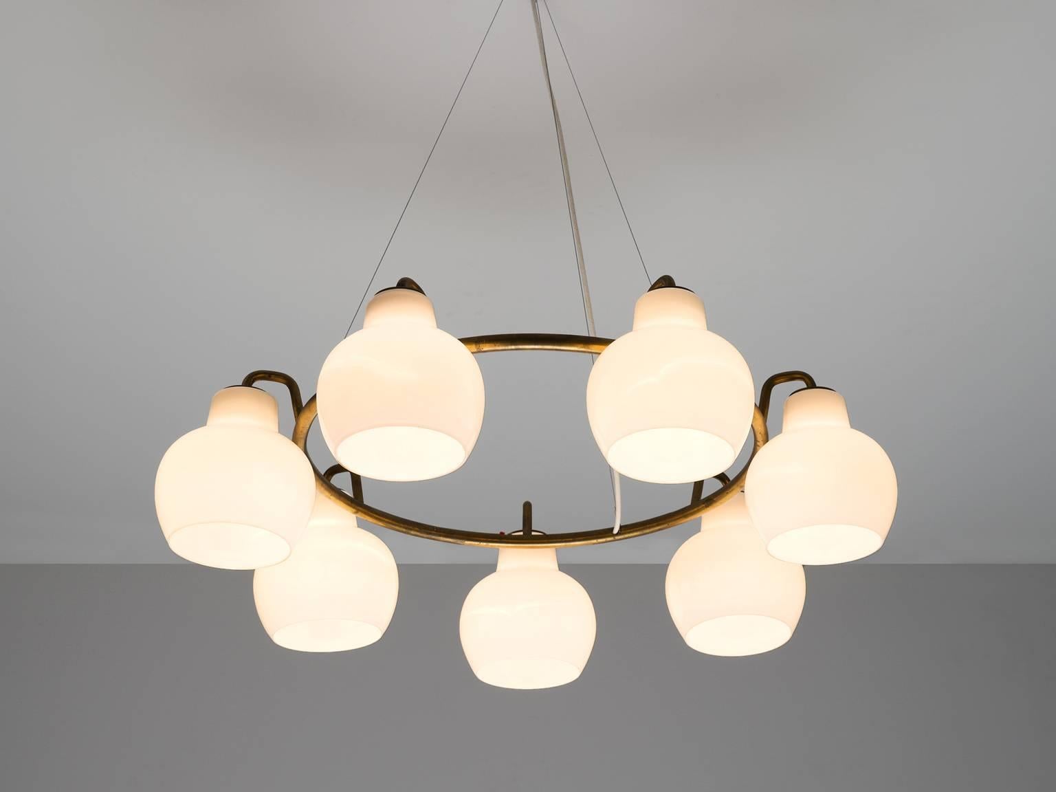 'Christiansborg' chandelier, in brass and opaline glass, by Vilhelm Lauritzen for Louis Poulsen, Denmark, 1950s.

The brass finished ring contains seven opaline glass shades with a shiny finish to create an excellent light partition. The frame