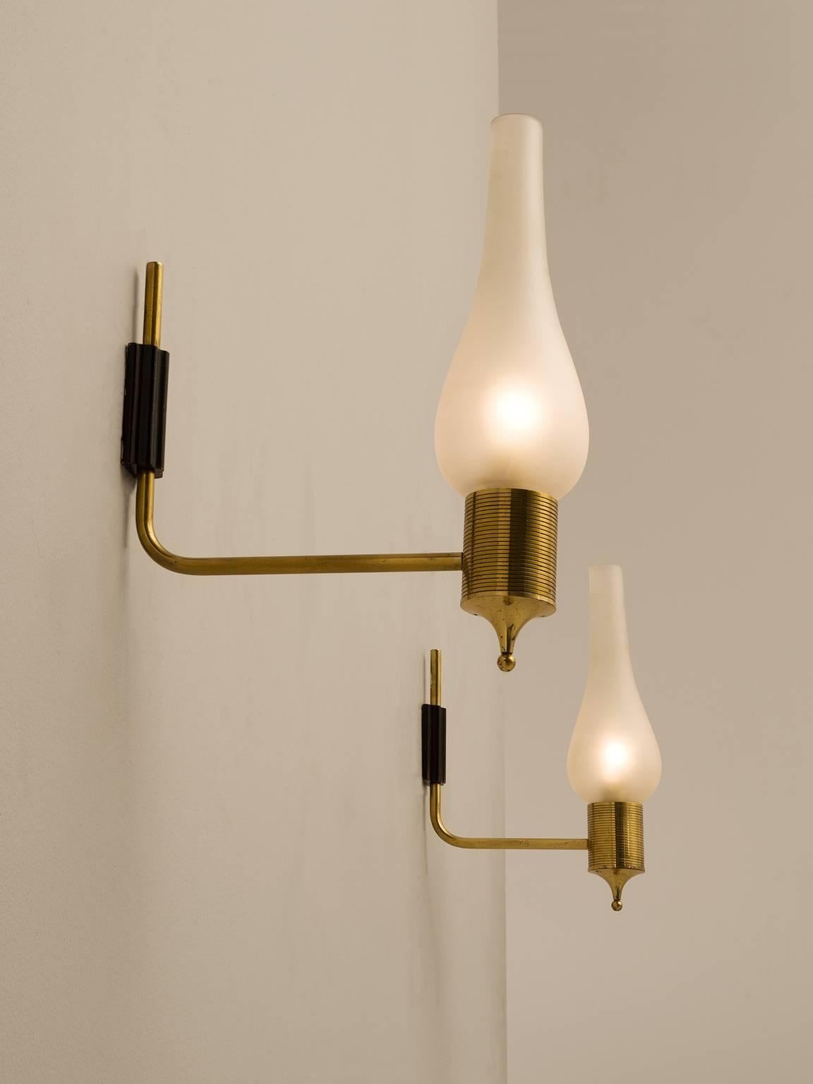 Pair of wall lights, in brass, metal and glass, for Maison Arlus, France 1950s. 

Elegant pair of wall lights. These lights remind of classical candle stick holders. A brass fixture, nicely decorated under the glass. The frosted glass has an elegant
